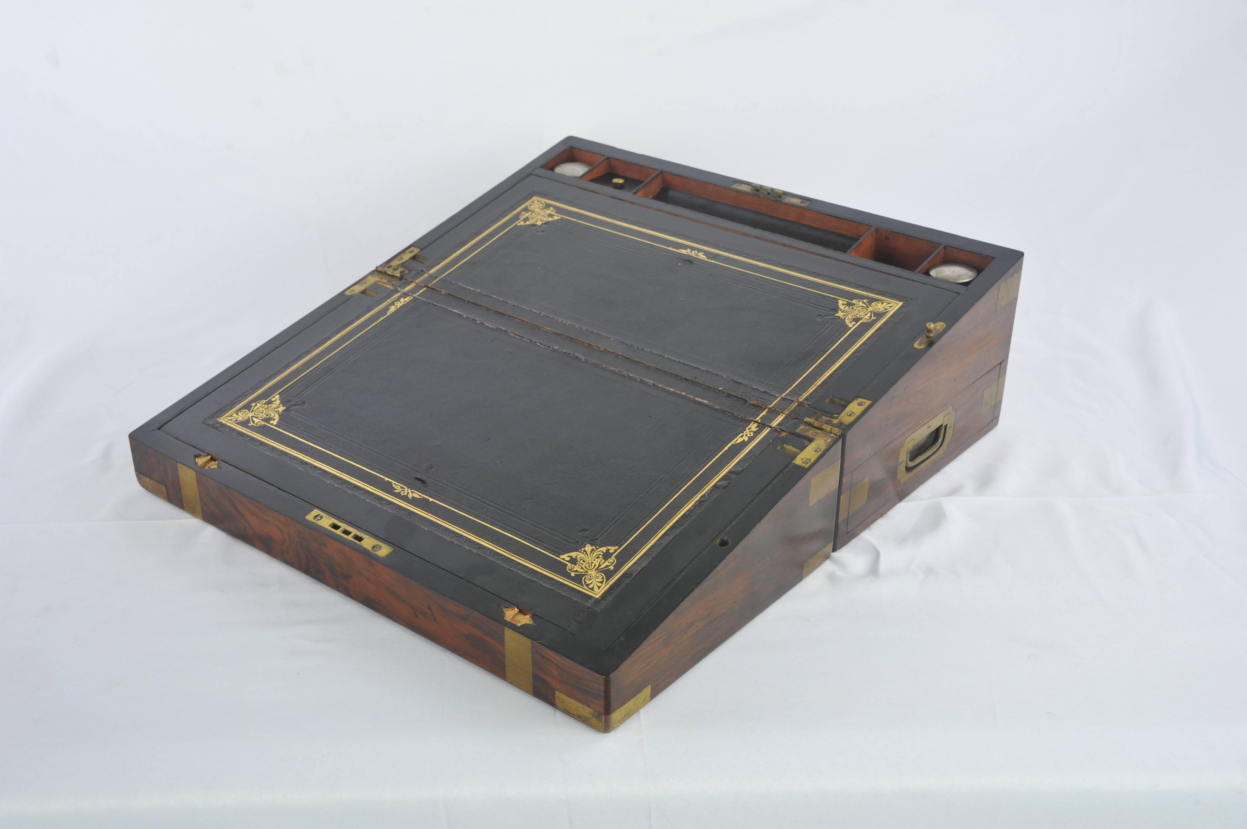Writing slope, antique Victorian lap desk, marine walnut brass, Scotland, 1870, B1081.

Scotland 1870
Figured walnut
Original brass straps and corner pieces
Opens to reveal a black embossed leather top
Double hinged slope
Pentray centre