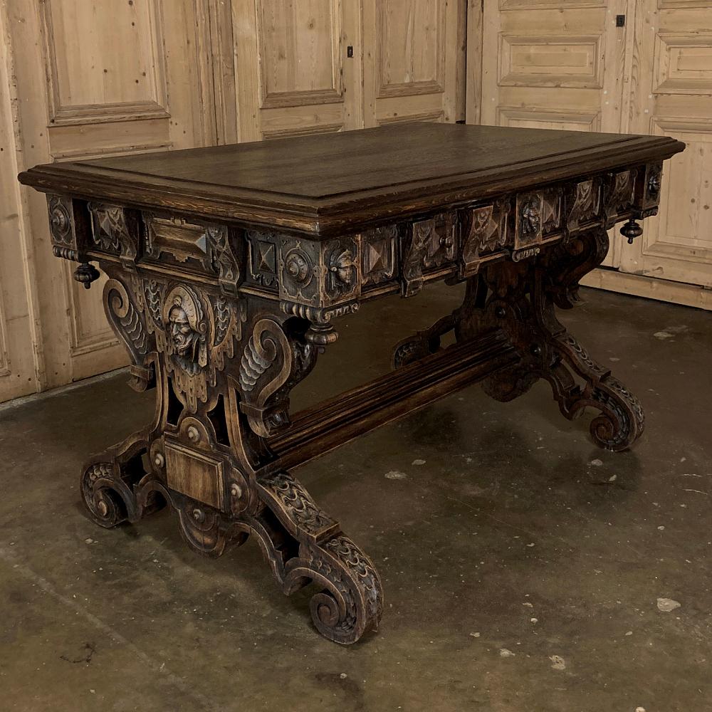 19th century French Renaissance writing table makes a great choice as a home office desk, an ancillary desk at the office, or as a luxuriously old world table for any room! Exquisitely hand carved from solid oak, it features a series of corbels