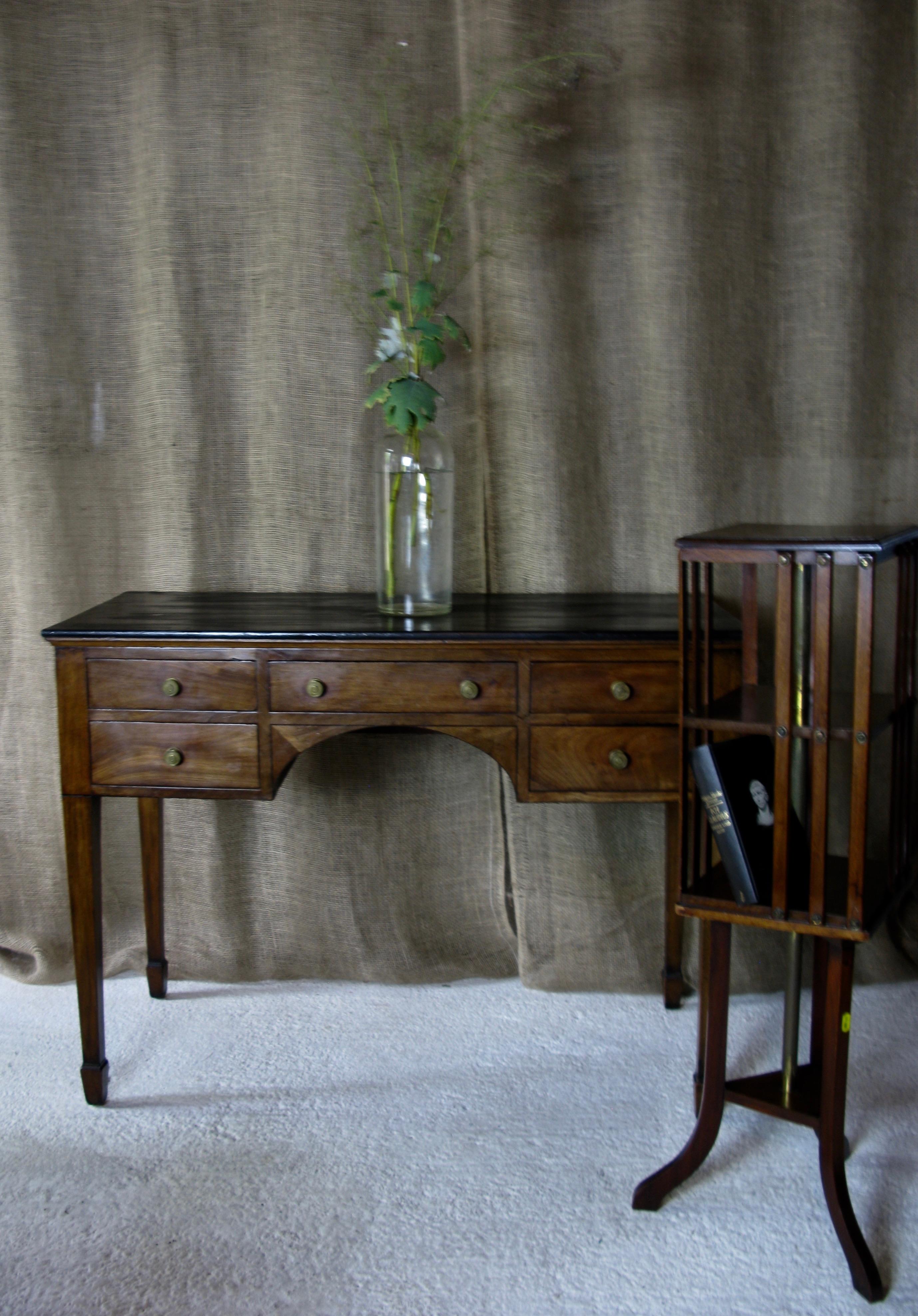 A fine Georgian mahogany writing, side occasional table with a lovely honey color.
In the French taste‚ a black polished top above 5 drawers with original brass knobs, raised on square tapering legs ending on wider square feet

Perfect height for