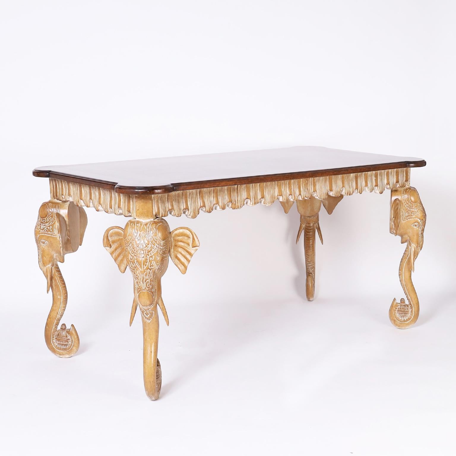 Mid century Italian one drawer writing table with a walnut top having a decorative beveled edge on a pickled or white washed bleached walnut base with a pleated apron and carved elephant head legs.