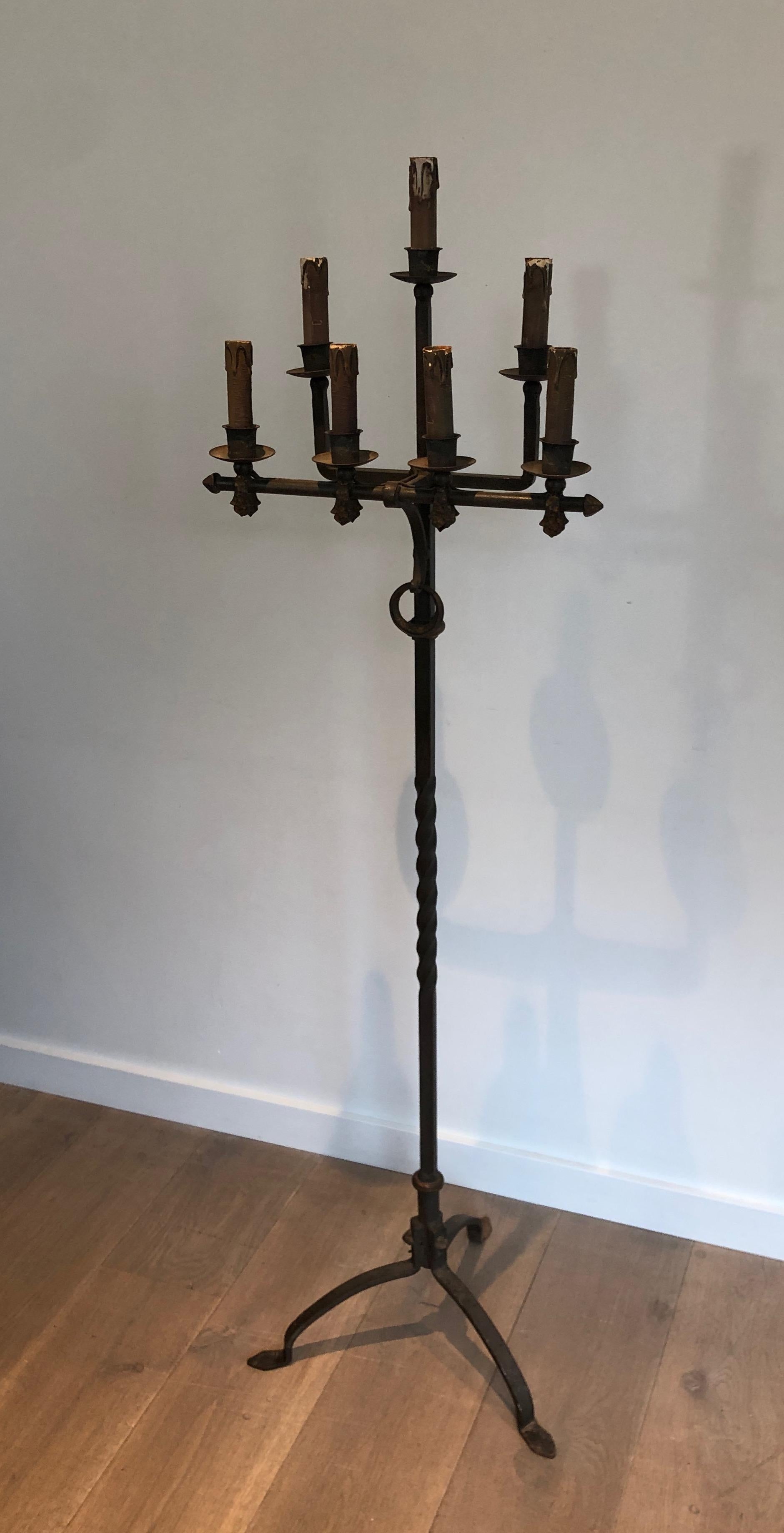 This 7 lights floor lamp is made of wrought iron and gilt iron. The quality of this candelabra is very good and the wrought iron work, very fine. This is a French work, circa 1940.