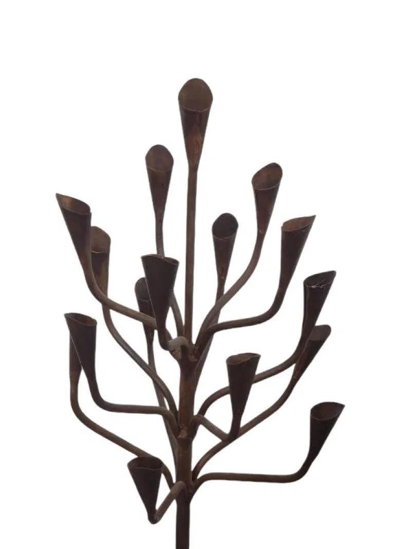 This stunning wrought iron 16-light candle holder tree makes a bold statement in any room. With its intricate, tree-like design, it features a combination of elegant curves and sturdy iron craftsmanship.