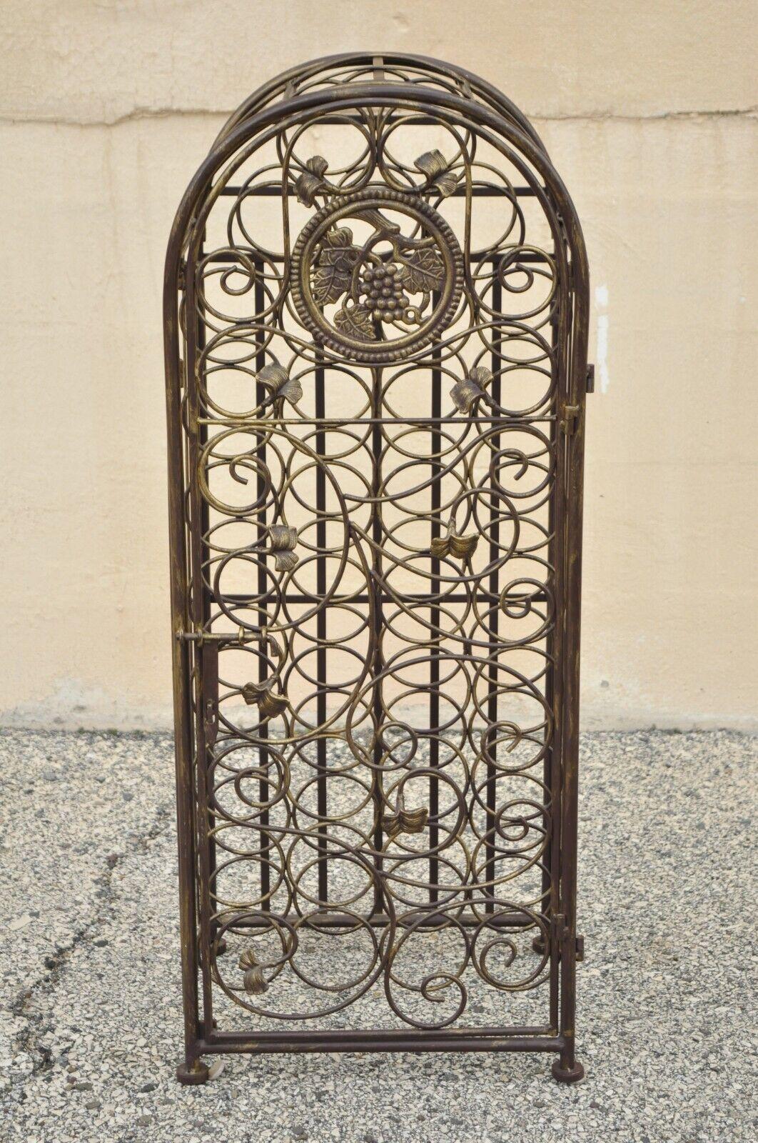 Wrought iron 37 wine bottle slot holder stand with door Victorian style. Item features 37 bottle slots, grapevine and leaf design to front door, wrought iron construction, distressed finish, great style and form. Circa late 20th century.
