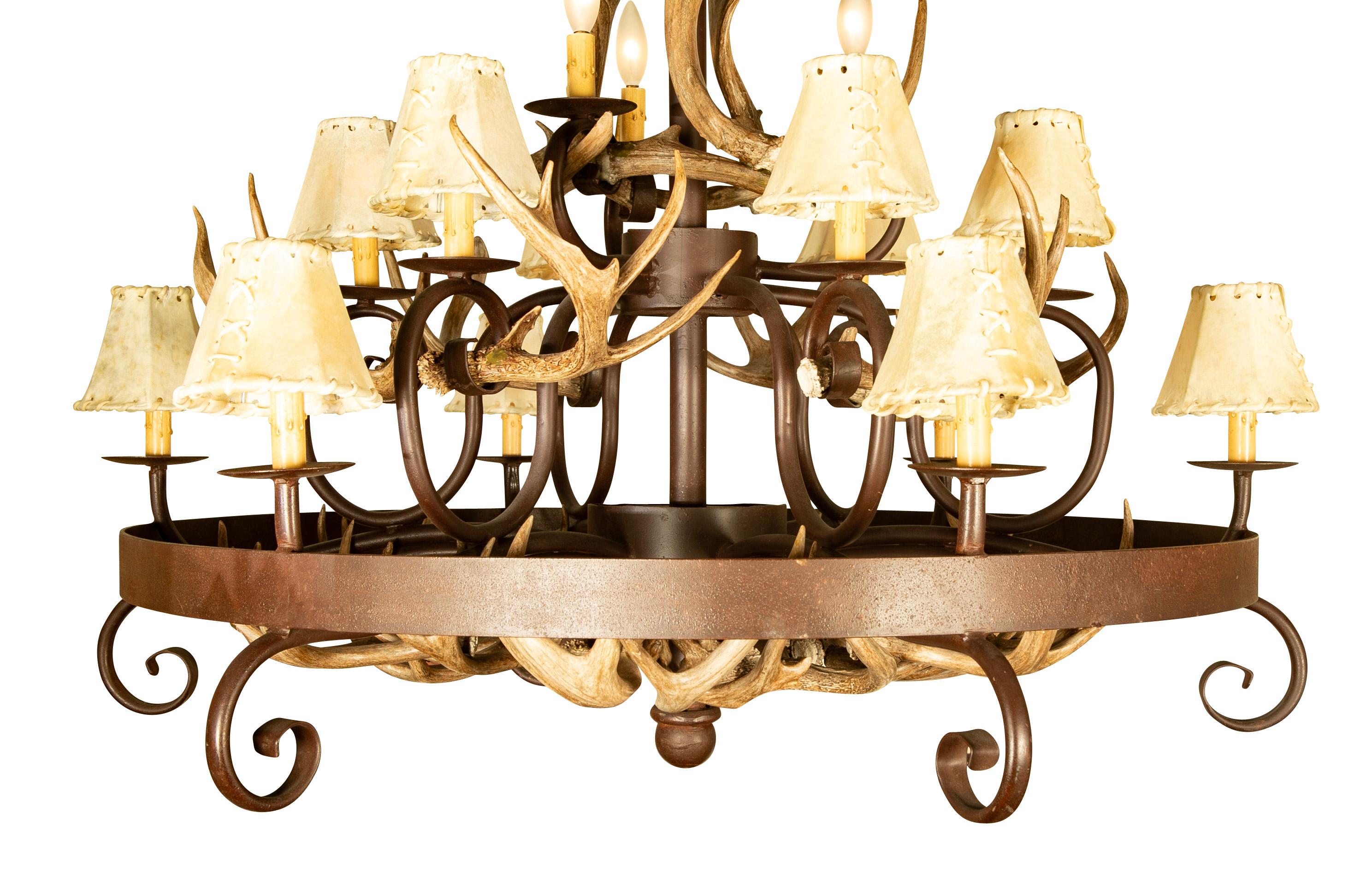 Wrought iron and deer antler fifteen light chandelier with three tiers of light. An impressive chandelier, great for a Adirondack mountain house or Western ranch, a ski lodge, or any rustic or country interior. The first two tiers with hand stitched