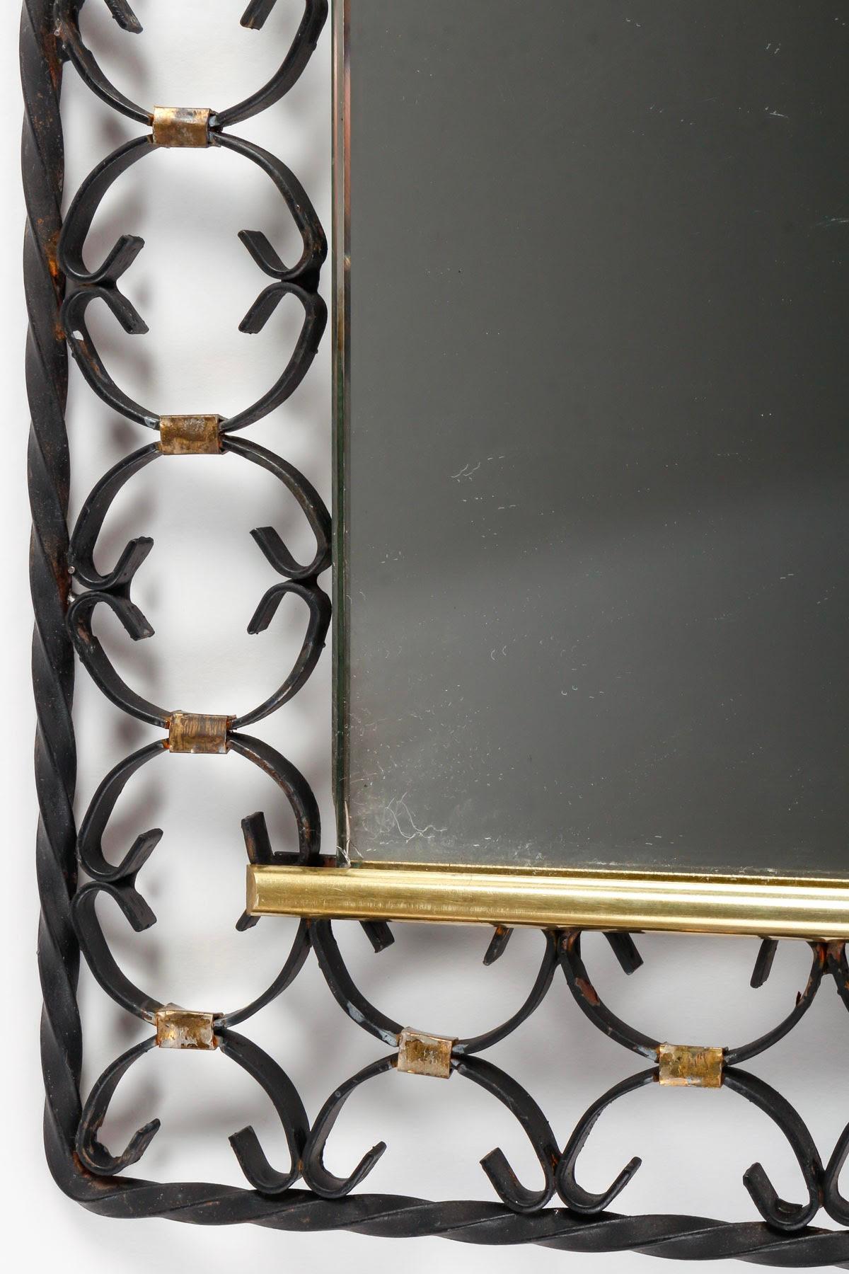 Wrought iron and brass mirror, 1950s-1960s design.

Mirror from the 1950s-1960s in painted wrought iron and brass, mid XXth century design.

Dimensions: h: 39cm, w: 34cm, d: 1cm