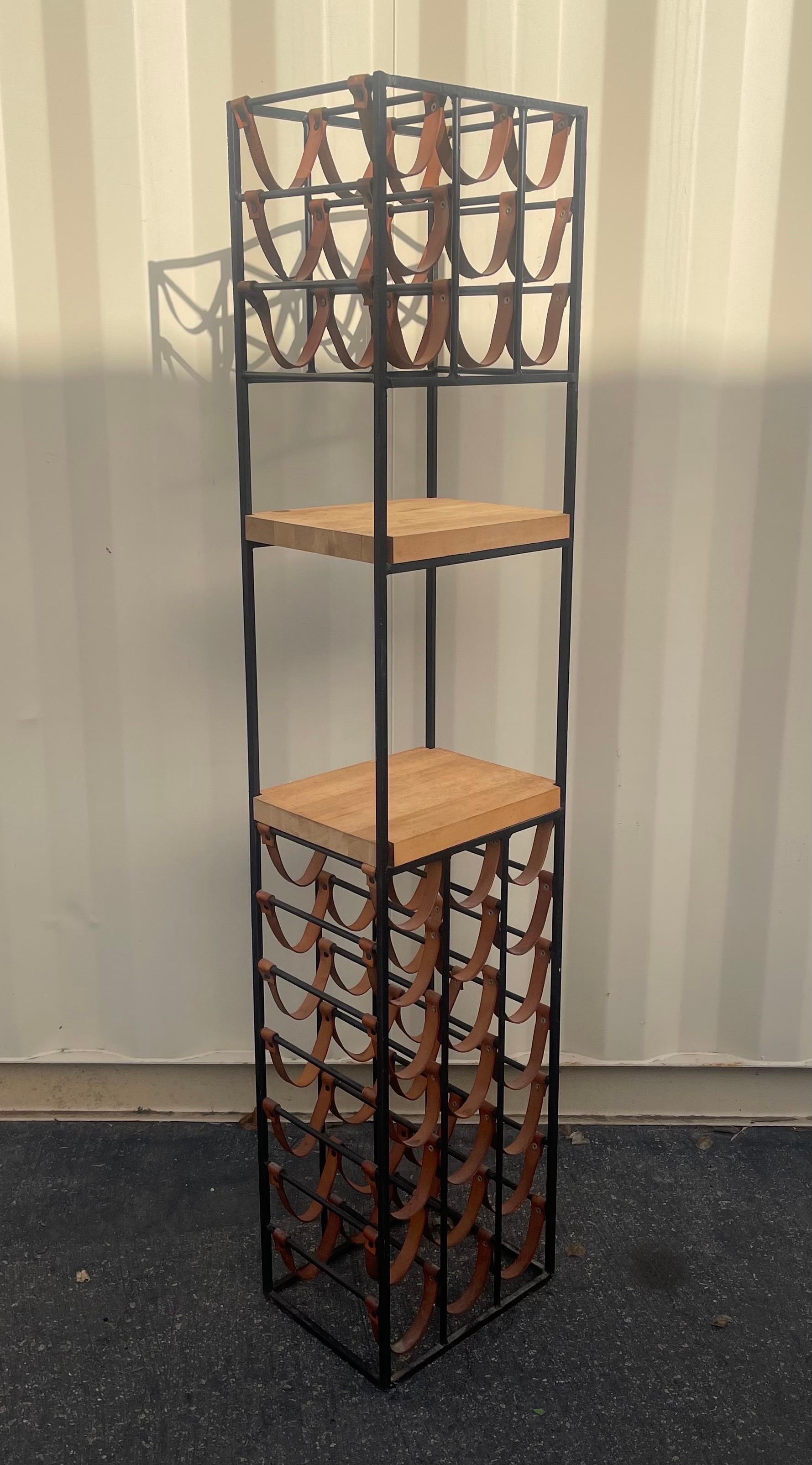 Wrought iron and butcher block thirty bottle wine rack by Arthur Umanoff, circa 1950s.  The tower unit measures 14
