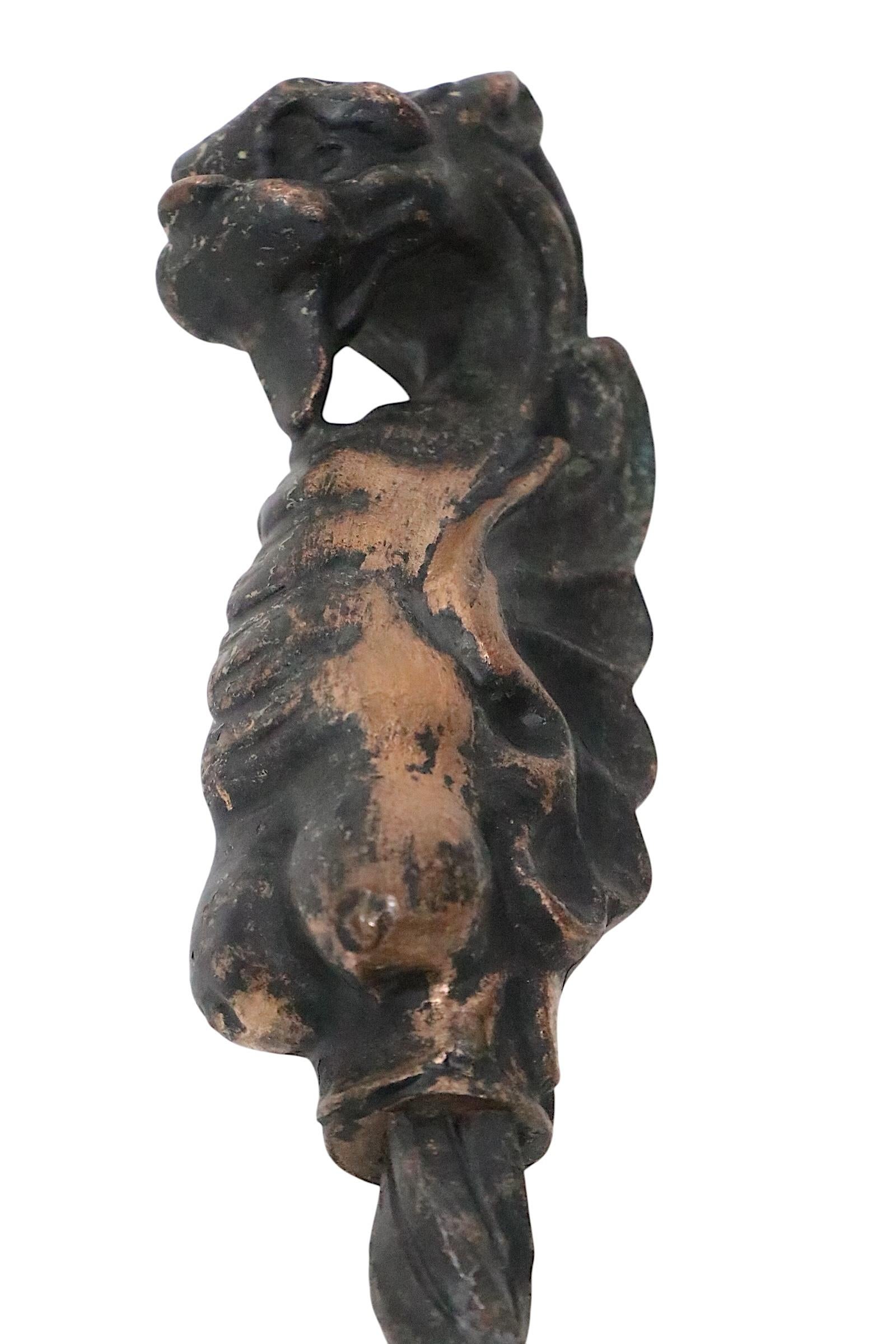 Exceptional 19th century set of wrought iron and cast bronze fireplace tools, with dragon, griffin handles. The set features inscribed line drawn decorative surfaces, with twisted and handworked details. Highly unusual and well crafted set, rare to