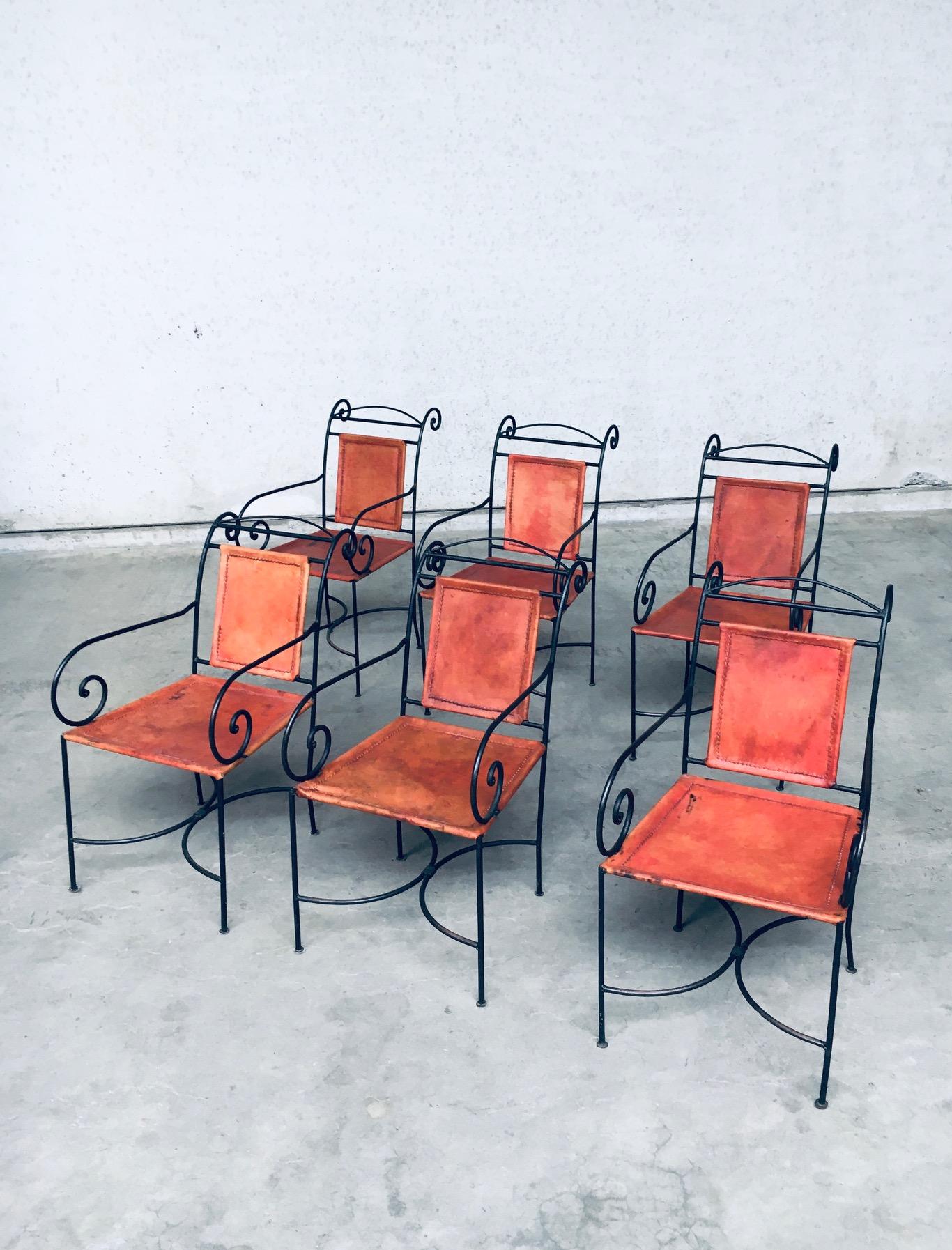 Vintage Design wrought iron and cognac leather dining chair set of 6, made in Spain 1960's. Swirl shaped wrought iron metal frame with thick cognac colored leather seat and back. Hand crafted and forged. All chairs have a nice patina on the leather