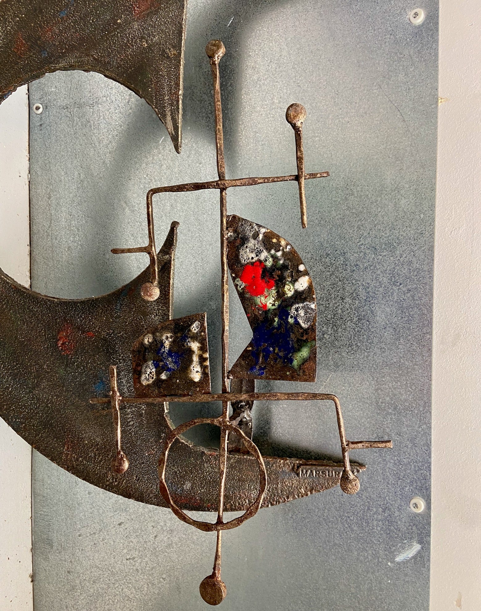 A large wrought iron and enamel brutalist wall sculpture by Salvino Marsura circa 1970's 
with red blue white and green enamel
there is a possibility that it could also be turned into a wall light / sconce.
Signed front and back. 
Please note that