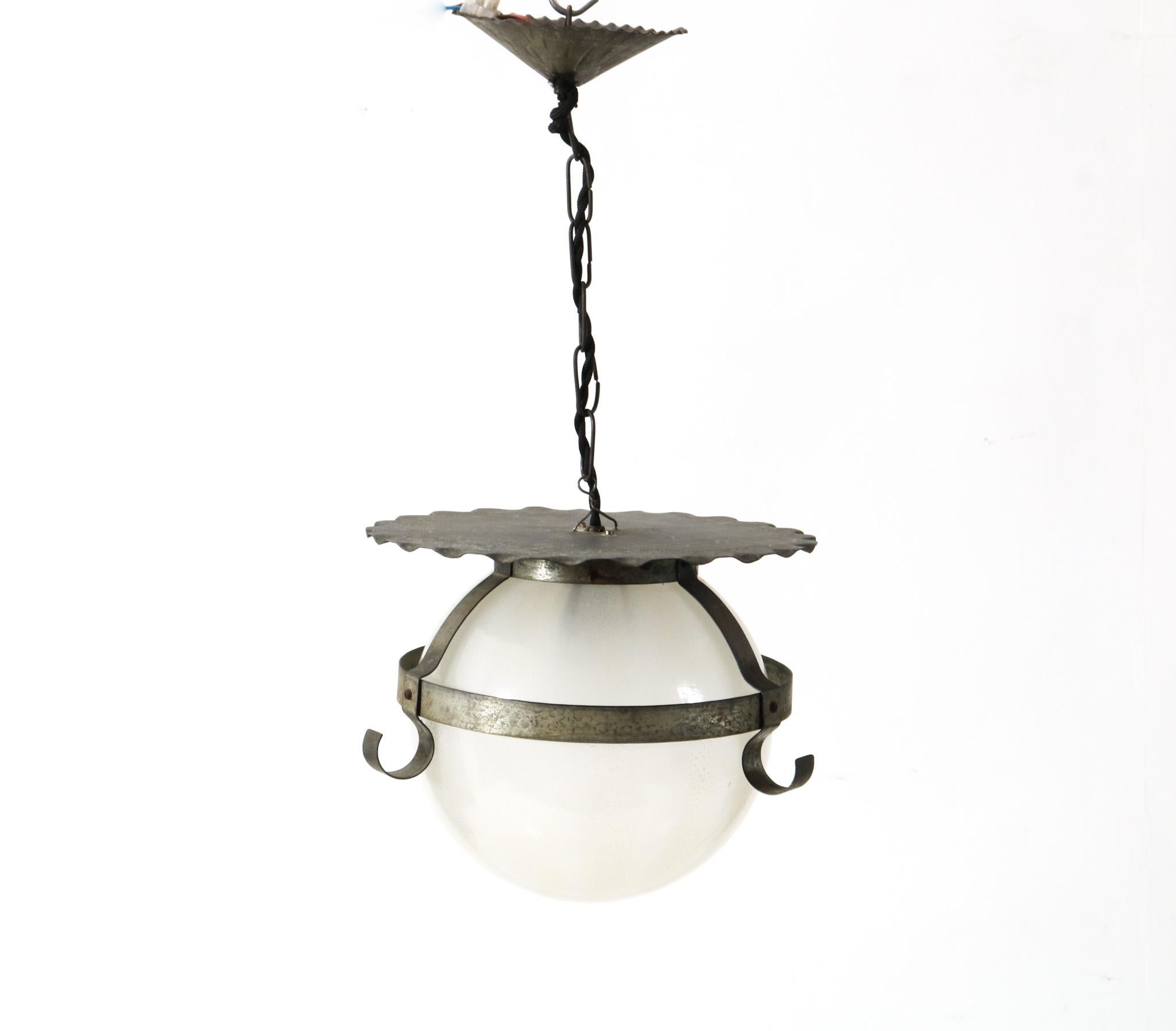 Stunning Art Deco Amsterdamse School pendant lamp.
The original glass spherical is designed by A.D. Copier and the original wrought iron frame is designed by Frits Lensvelt for Glasfabriek Leerdam.
Striking Dutch design from the 1930s.
This