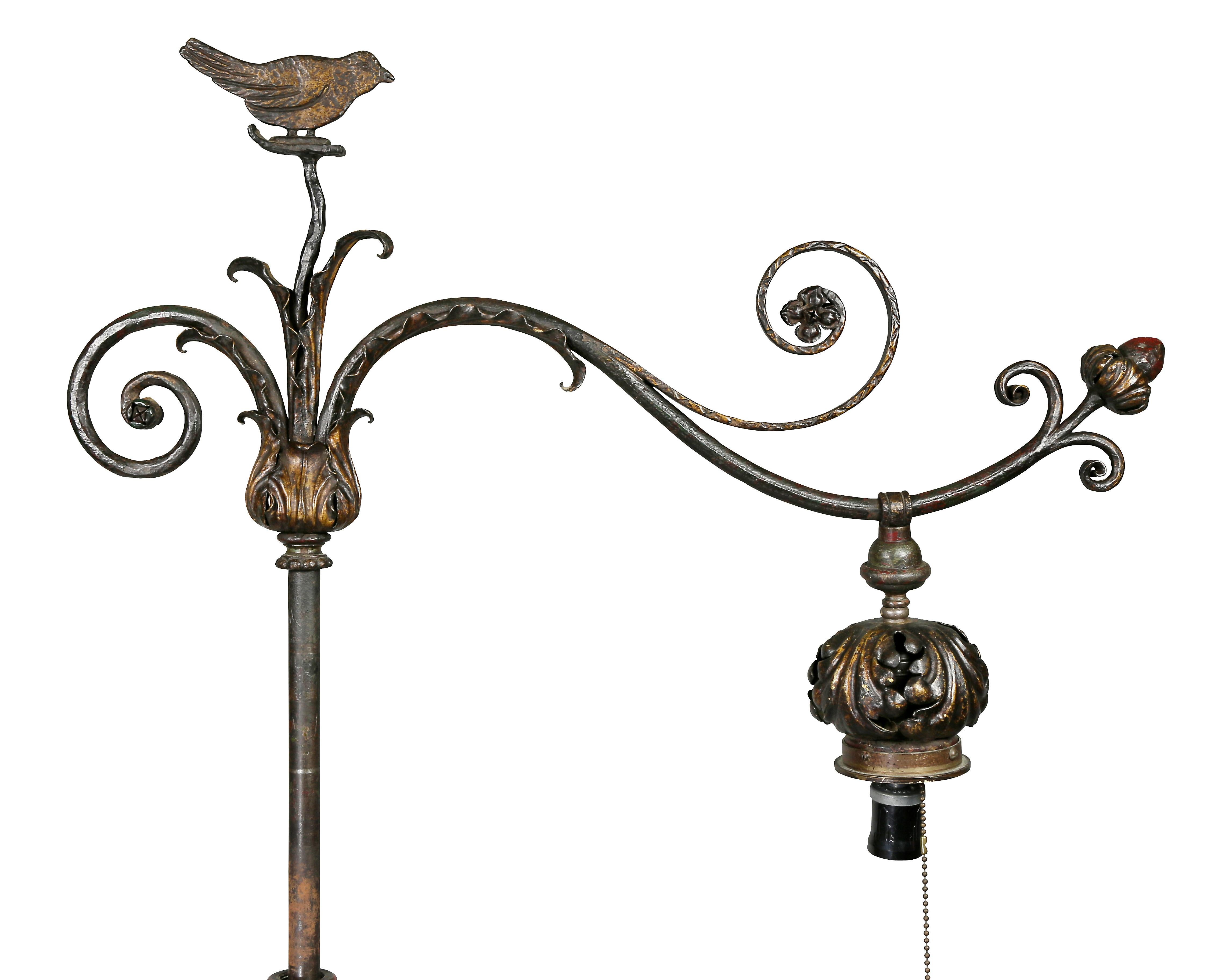 Wonderfully whimsical with a singing bird atop the arm for the light and scrolled designs, shaped support with flower heads and leaf design joining four scrolls and a circular marble base. Great old paint highlights and patina.