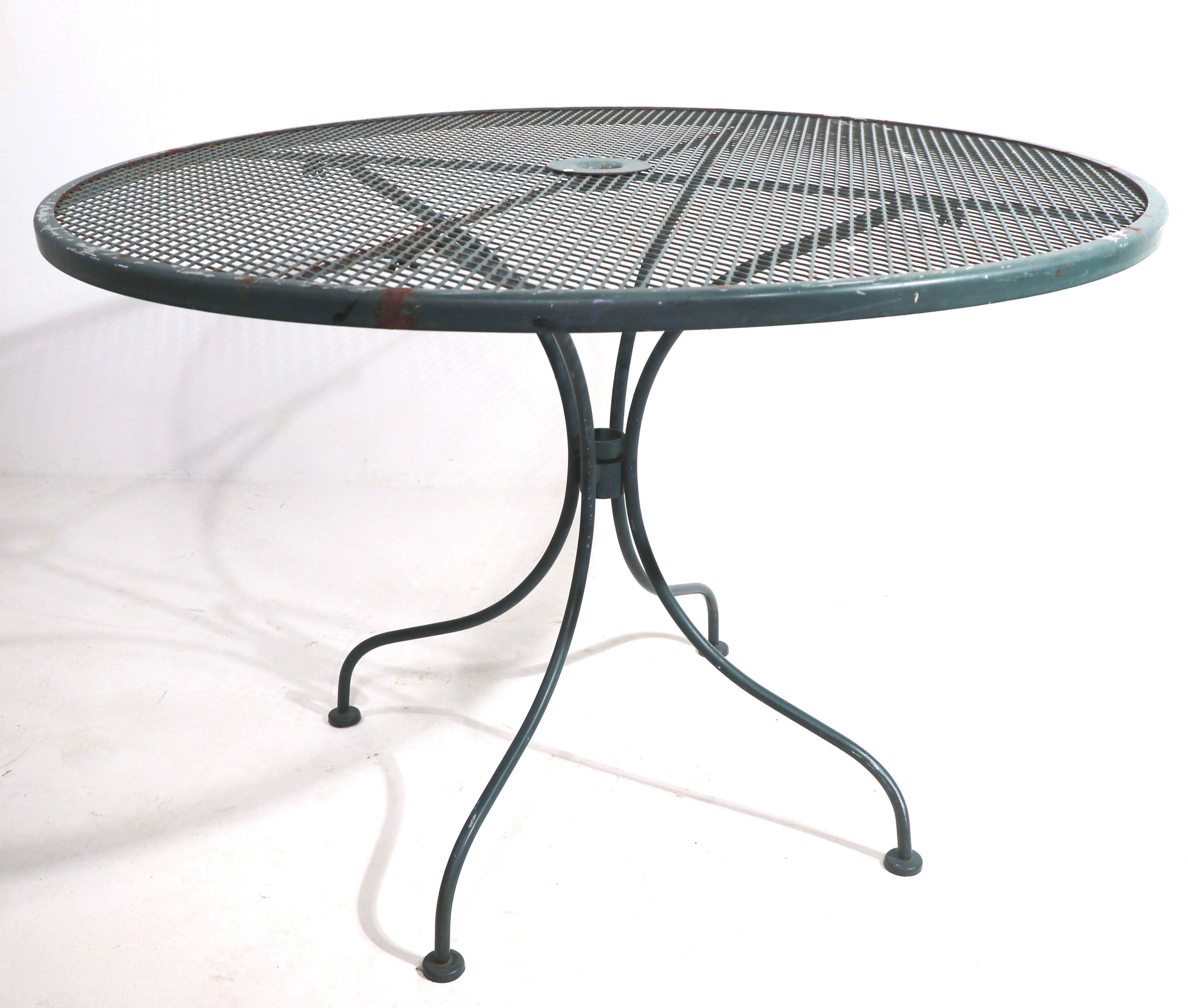 Stylish metal dining table suitable for garden, patio and or poolside use. The table is in very good original condition, free of structural damage or repairs, showing only light cosmetic wear, normal and consistent with age.
