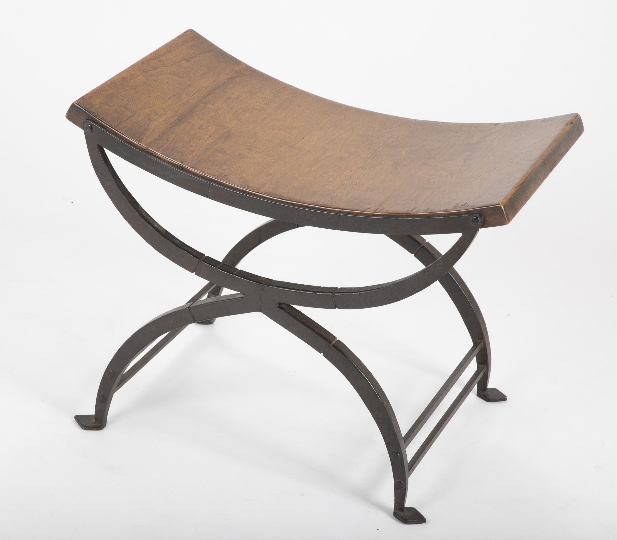 Handwrought iron stool with polished oak seat attributed to Morgan Colt of New Hope, Pennsylvania. A handsome piece, great for an entryway, the foot of a bed or any room in need of distinctive seating. 

Morgan Colt (1876-1926) was one of the most