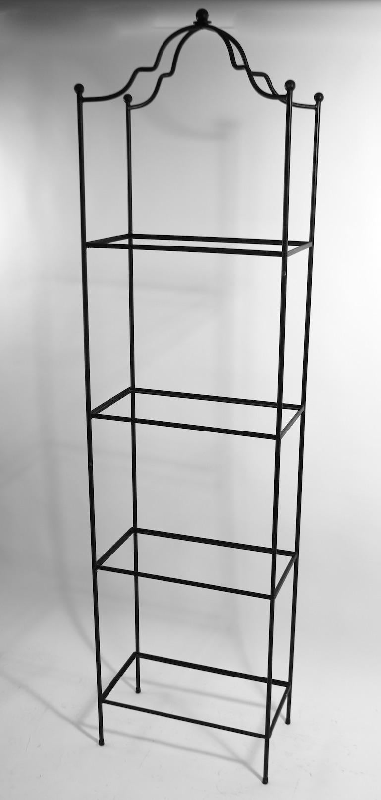 Stylish freestanding shelf of wrought iron and textured glass. This chic architectural étagère features four rectangular shelves, heights as follows L to H 6, 23, 40, 57. Perfect for display or use in a kitchen or bathroom, or possibly in a