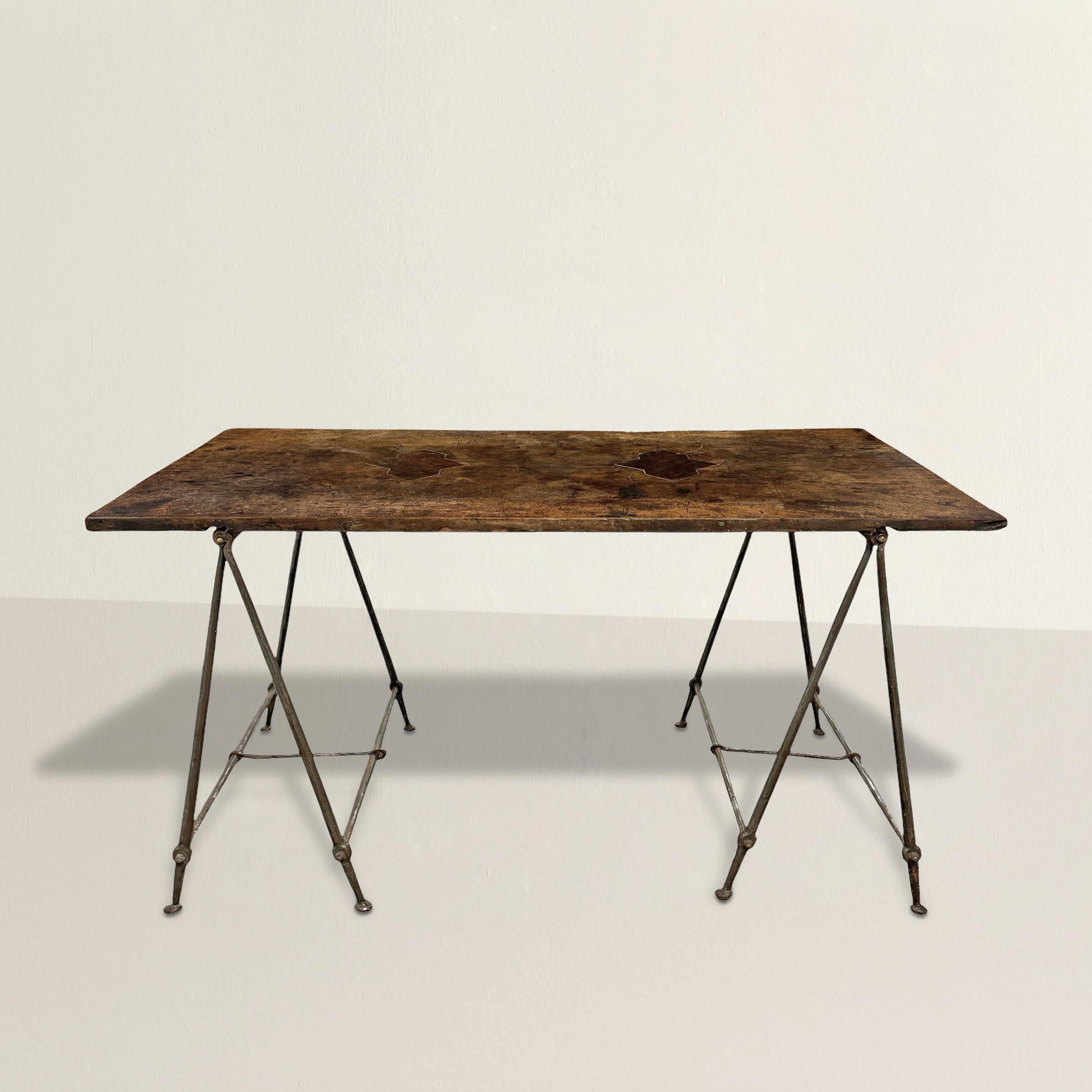 This striking table is a union of two eras, joined with effortless flair. The top began life as a 17th-century Spanish walnut table, worn smooth by centuries of use, its surface dappled with a rich patina that speak to a long, well-lived history.