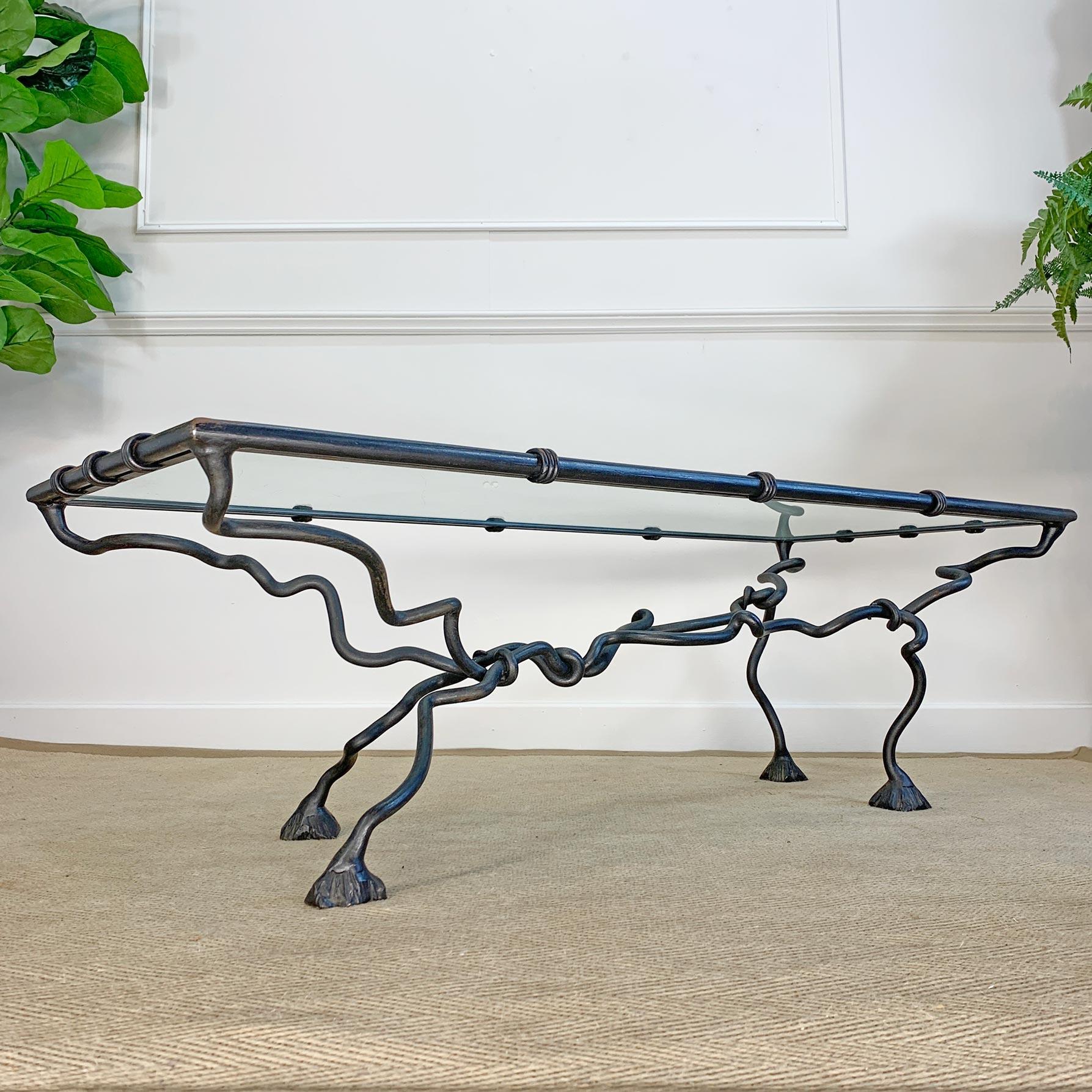 A wonderfully ornate hand crafted mid-century wrought iron coffee table, the legs worked and twisted to give the impression of a Leopard or Gazelle running, the animalistic design has been exceptionally well executed, with great attention given to