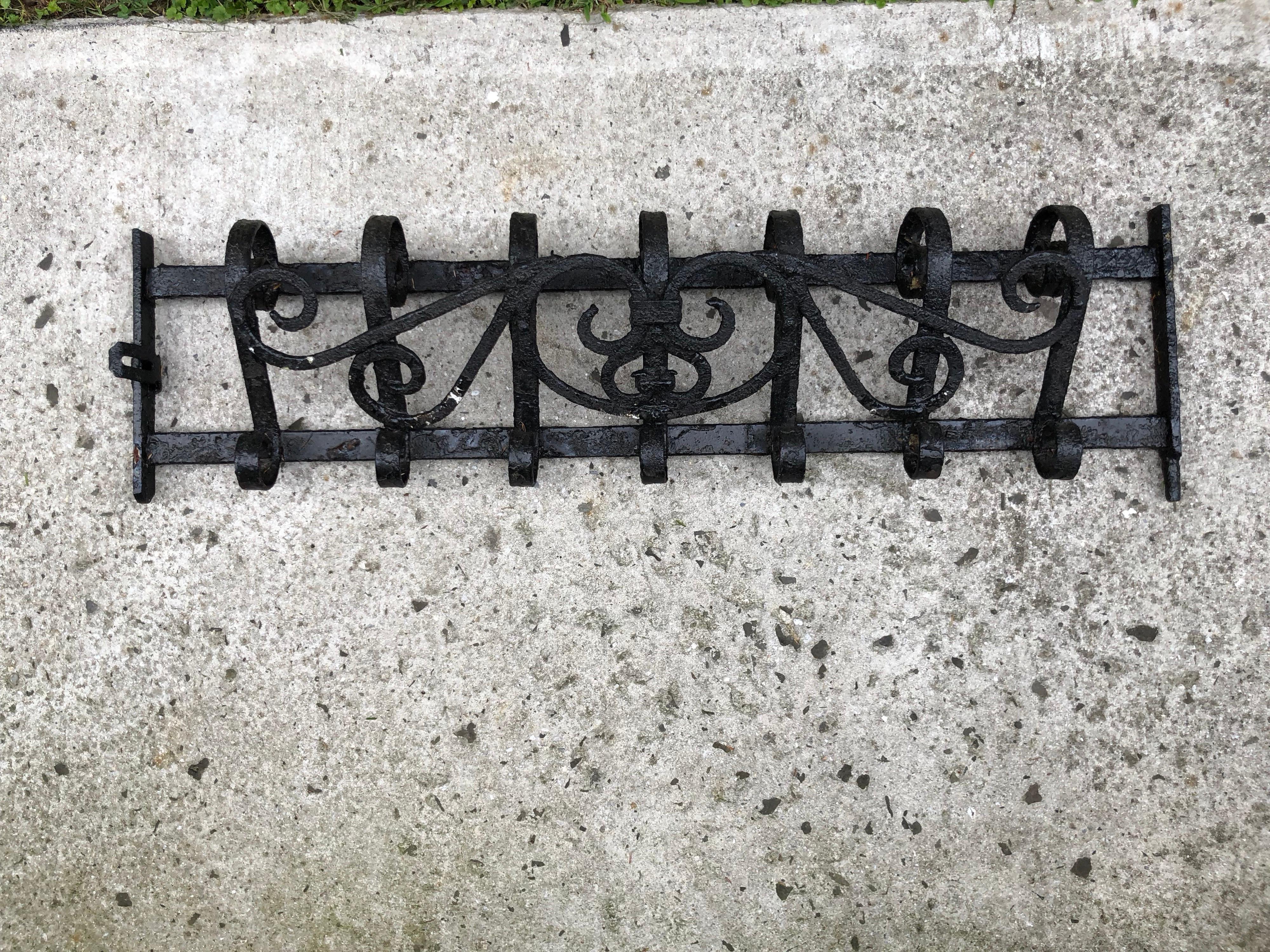 Wrought iron antique wall mount coat rack. Looking for a unique statement piece then this is it. Originally an ornate designed fragment from a window terrace or fence. Heavy and requires special hardware to mount to a sheetrock wall. Can also be