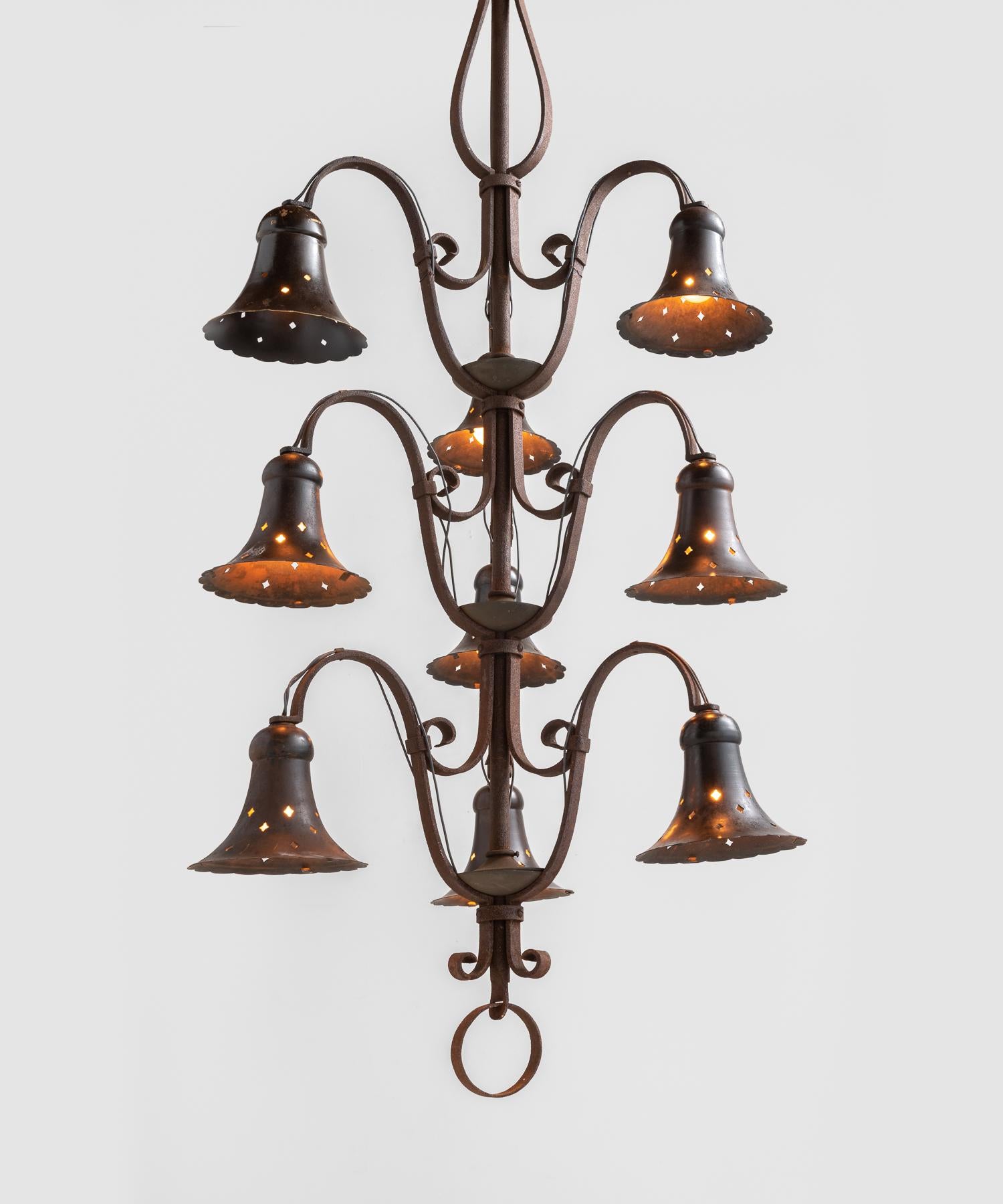 Wrought Iron Bell Chandelier, America, circa 1940

Nine-arm fixture with elegant perforated bell shades.