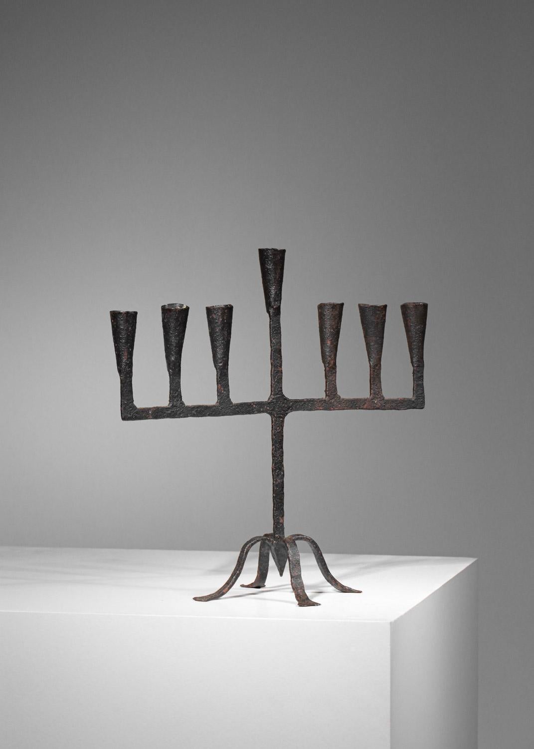 French Brutalist candleholder from the 60s, handmade and handcrafted, folk art. Wrought-iron candleholder structure with seven candle bases and a quadripod foot.  Beautiful vintage condition with traces of oxidation on the metal (see photos). We