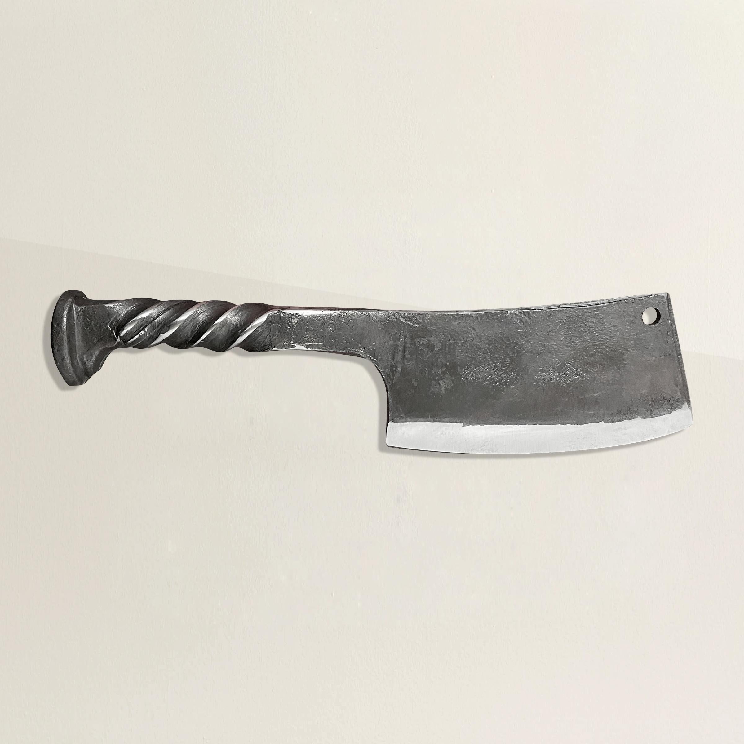 A handsome hand-wrought iron butcher's knife with a handle made from a railroad spike, and a thin sharpened blade. Perfect for slicing cheese and charcuterie at your next fête!