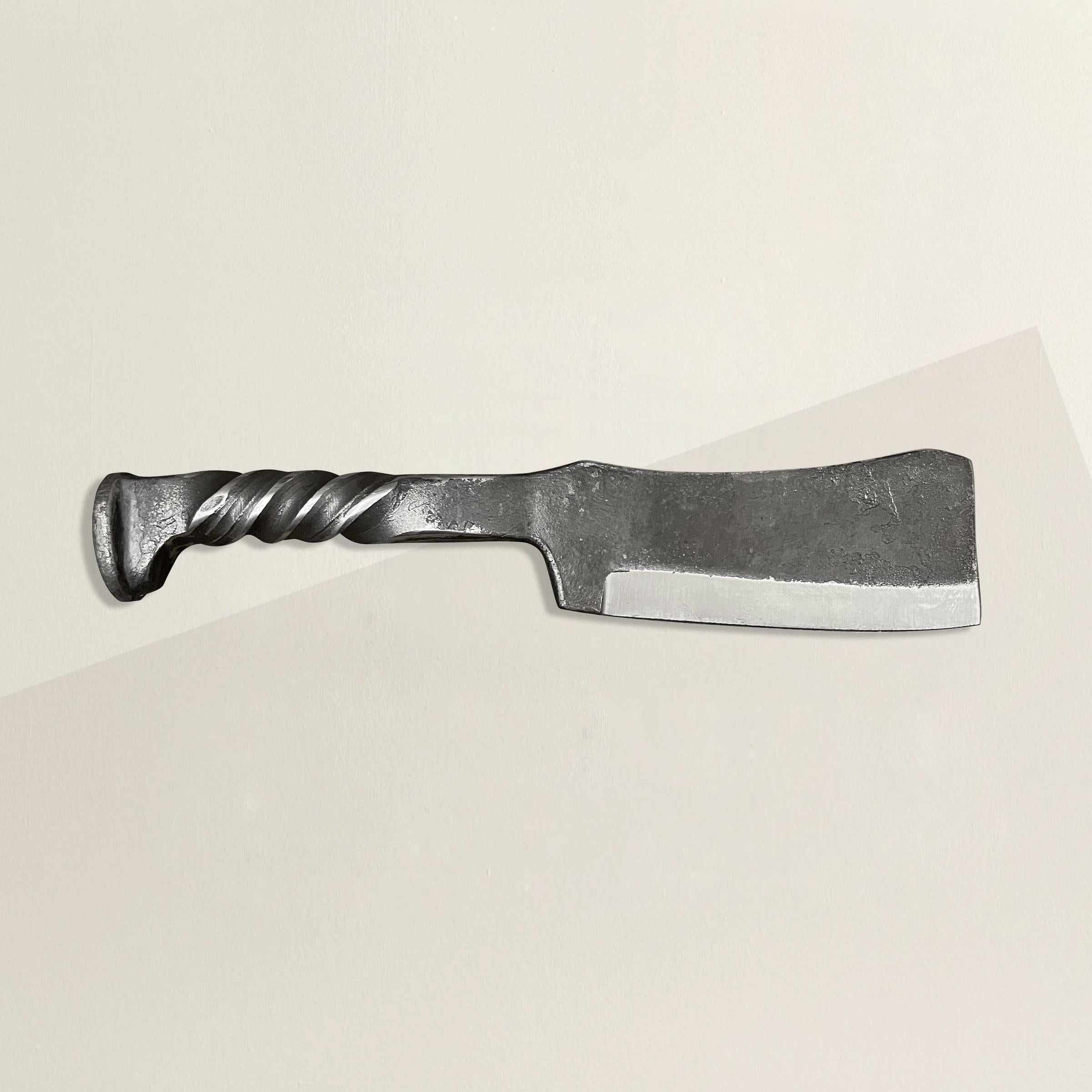 A handsome hand-wrought iron butcher's knife with a handle made from a railroad spike, and a thin sharpened blade. Perfect for slicing cheese and charcuterie at your next fête!