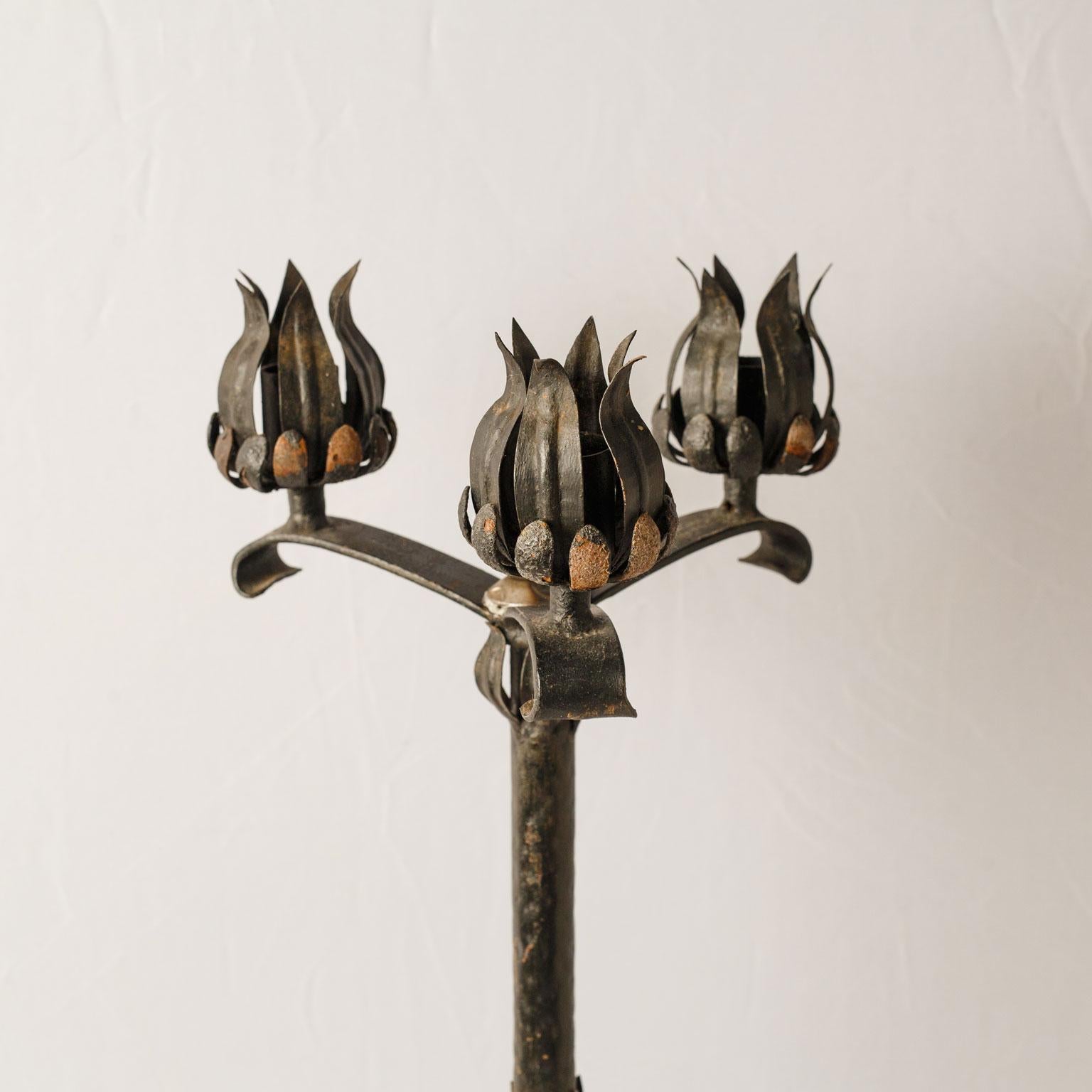 Wrought iron candelabra with three candleholders. Hand forged, solid with nice heavy weight. Currently unwired, but can be wired as a custom floor lamp for an additional cost.