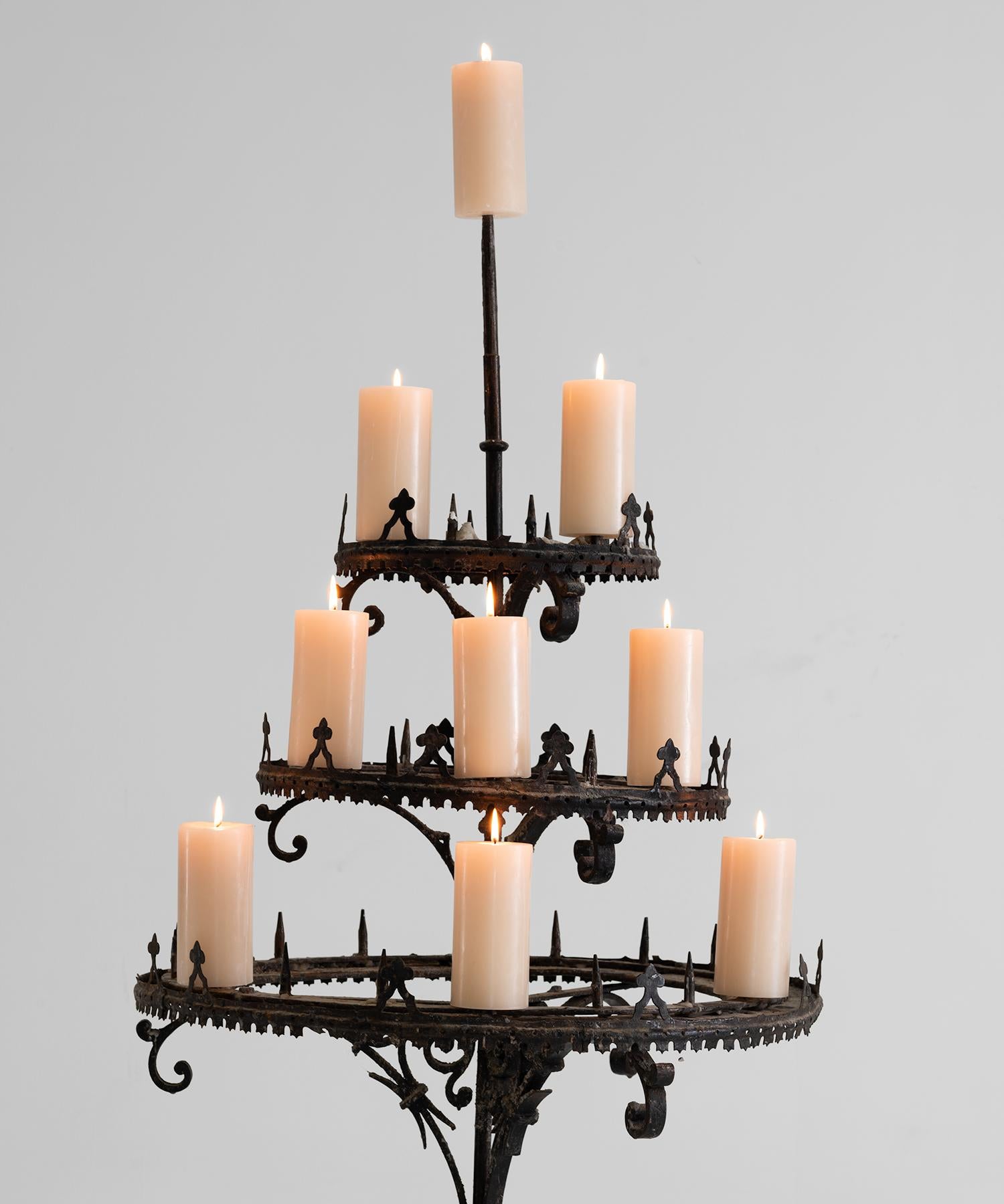Decorative iron candelabra with ornate details.