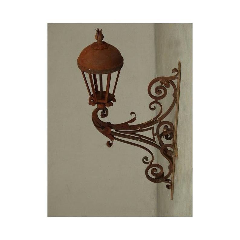 Wrought iron lantern decorated with scrolls and acanthus leaves. Made in the purest tradition of forge masters of the 19th century without welding or screws. These lanterns have been approved by the 