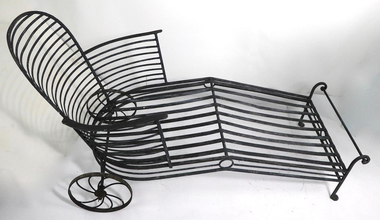 Vintage architectural wrought iron chaise lounge attributed to Salterini. Unusual Art Deco example, with fixed position backrest. Original, clean condition, showing only the expected cosmetic wear to finish, no structural damage, breaks or repairs.