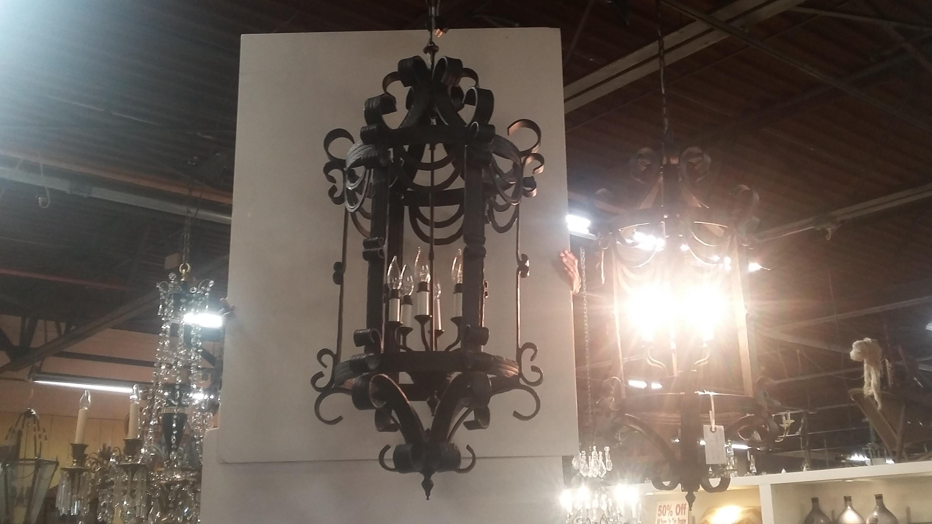 Classic wrought iron hanging foyer light. Extremely well made (there are 2 available) chandelier. Six lights in each. Made overseas (China) but quality is very good. Probably (estimate) over 75 lbs. each.
