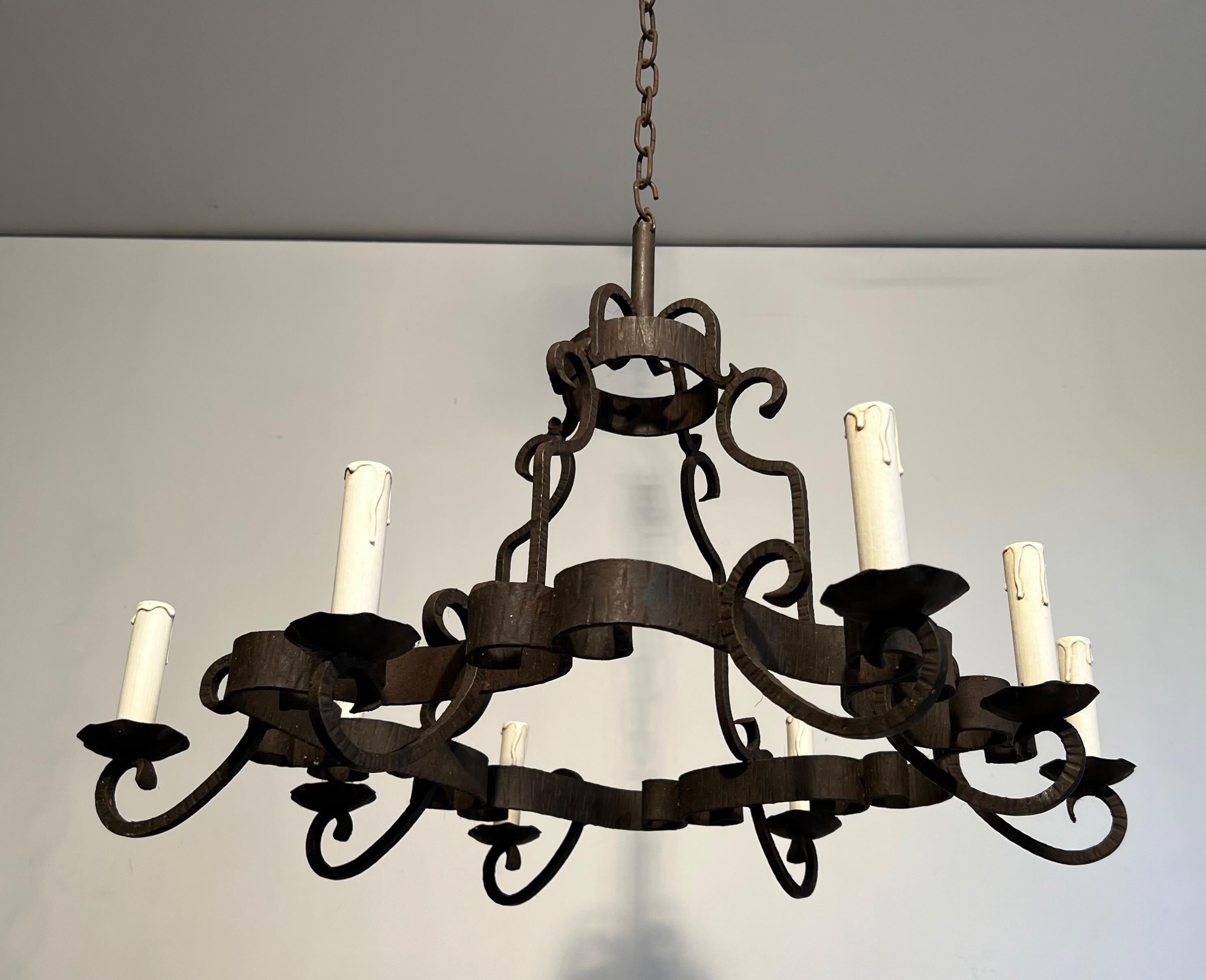 This 8 lights chandelier. is made of a wrought iron. This is a nice French work. Circa 1950
