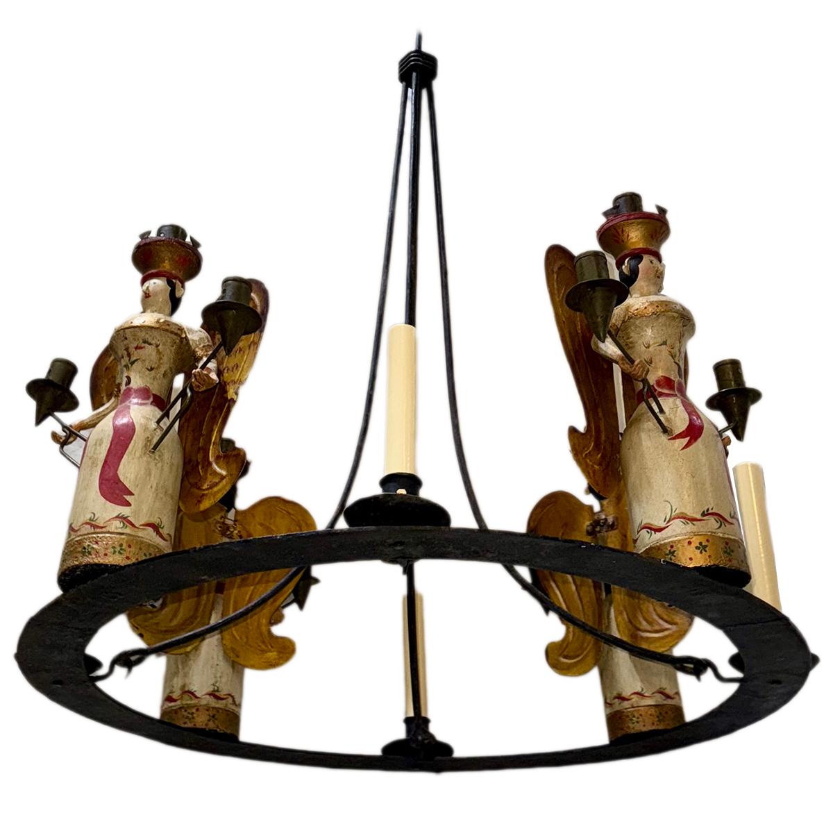 A circa 1940's Italian wrought iron chandelier with wooden angel candle holders.

Measurements:
Diameter: 28
