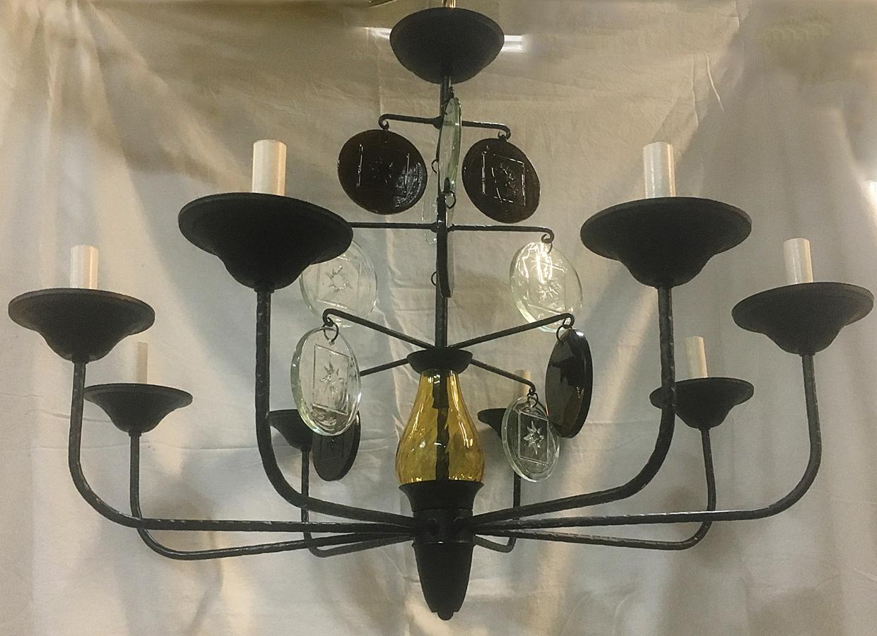 A Swedish wrought iron chandelier with molded glass body and pendants in amber and clear color, circa 1950s. Eight lights.
Measurements:
33
