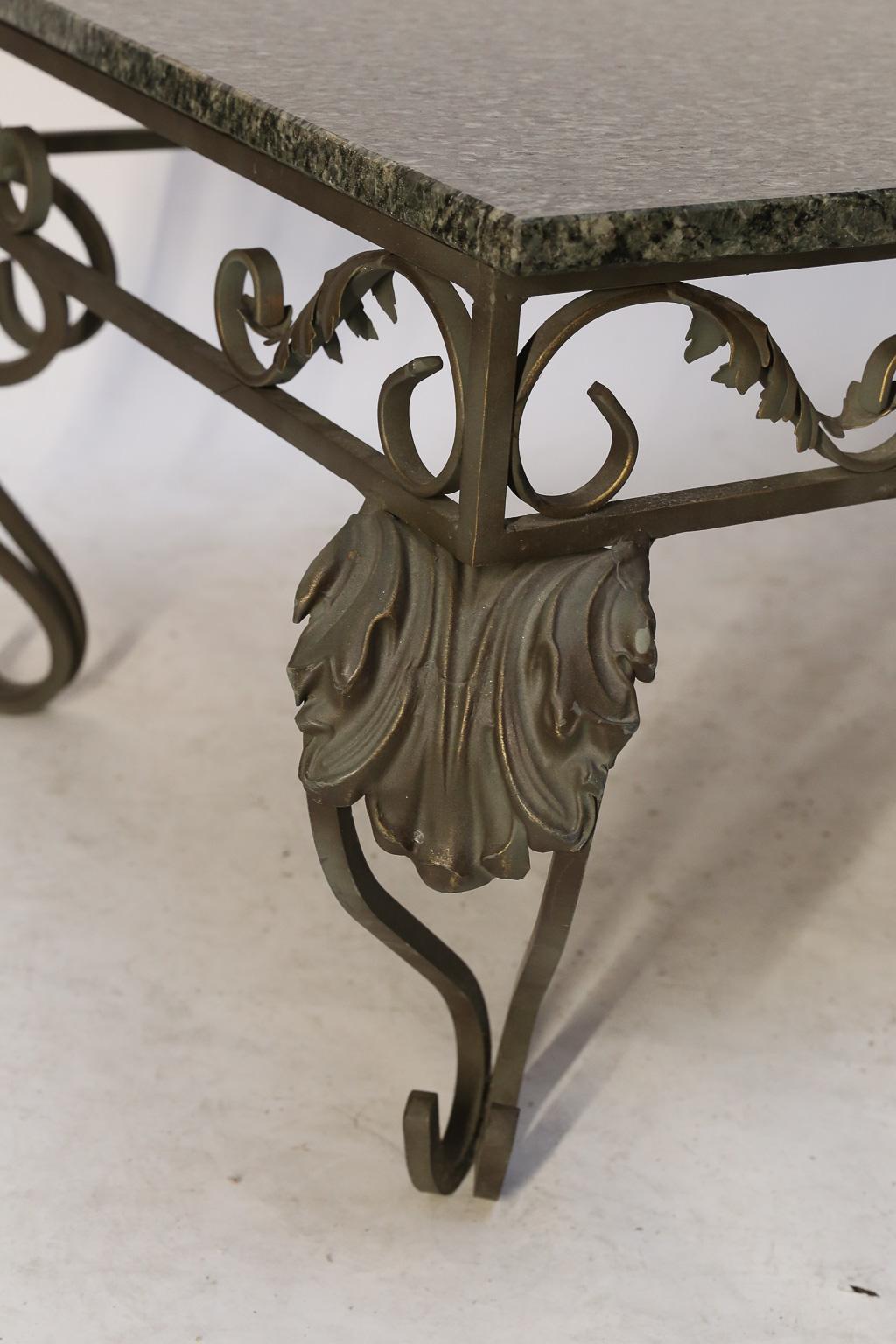 Wrought iron cocktail table base with cabriole legs features a filigree apron with acanthus leaves
details in the corners.

Top is green and black granite.
 