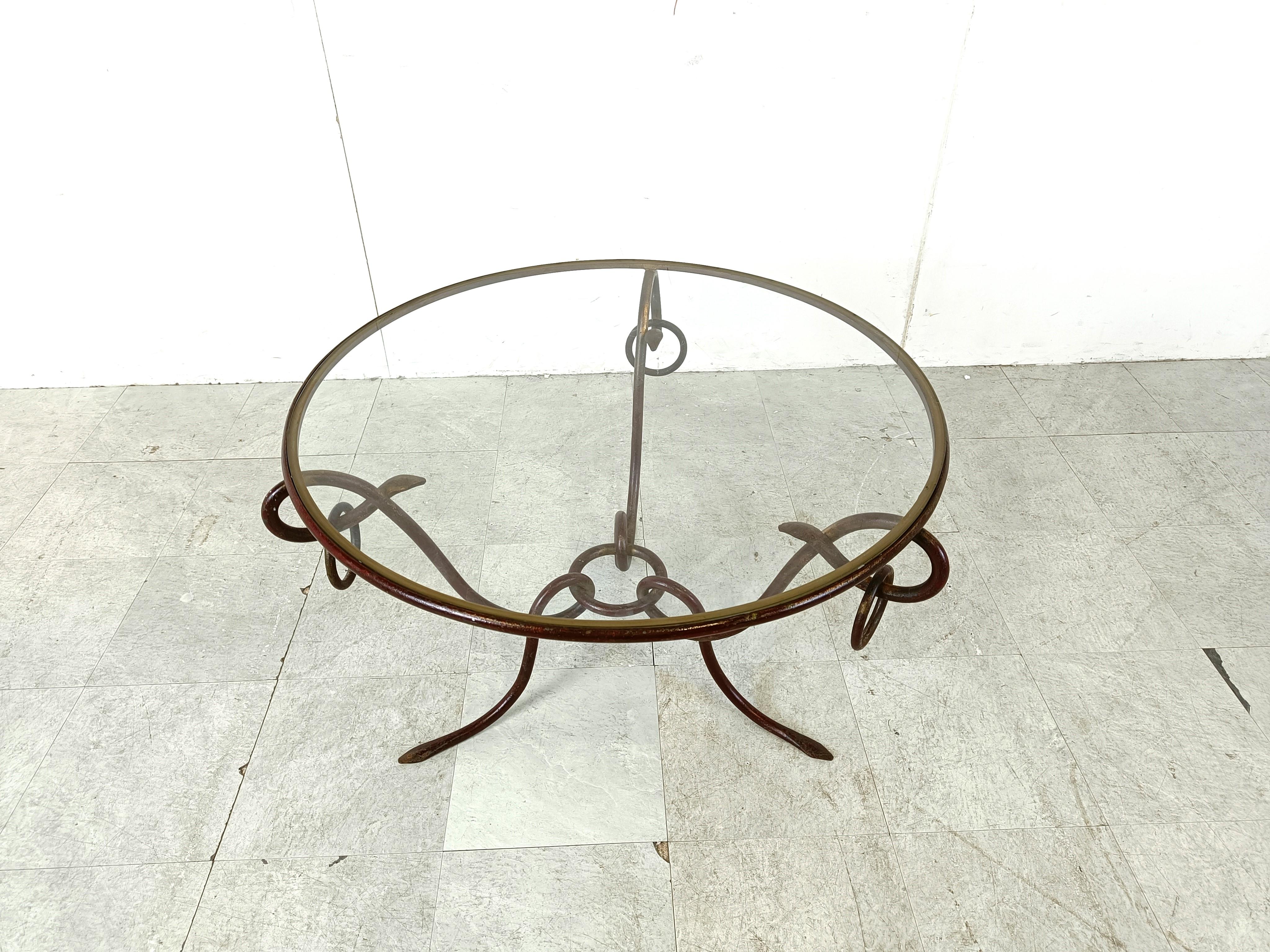 Vintage coffee table designed by René Drouet (1899–1993).

The table has a wrought iron base and a clear glass top. 

Wonderful craftsmanship.

1940s - France

Dimensions:
Height: 55cm/21.65