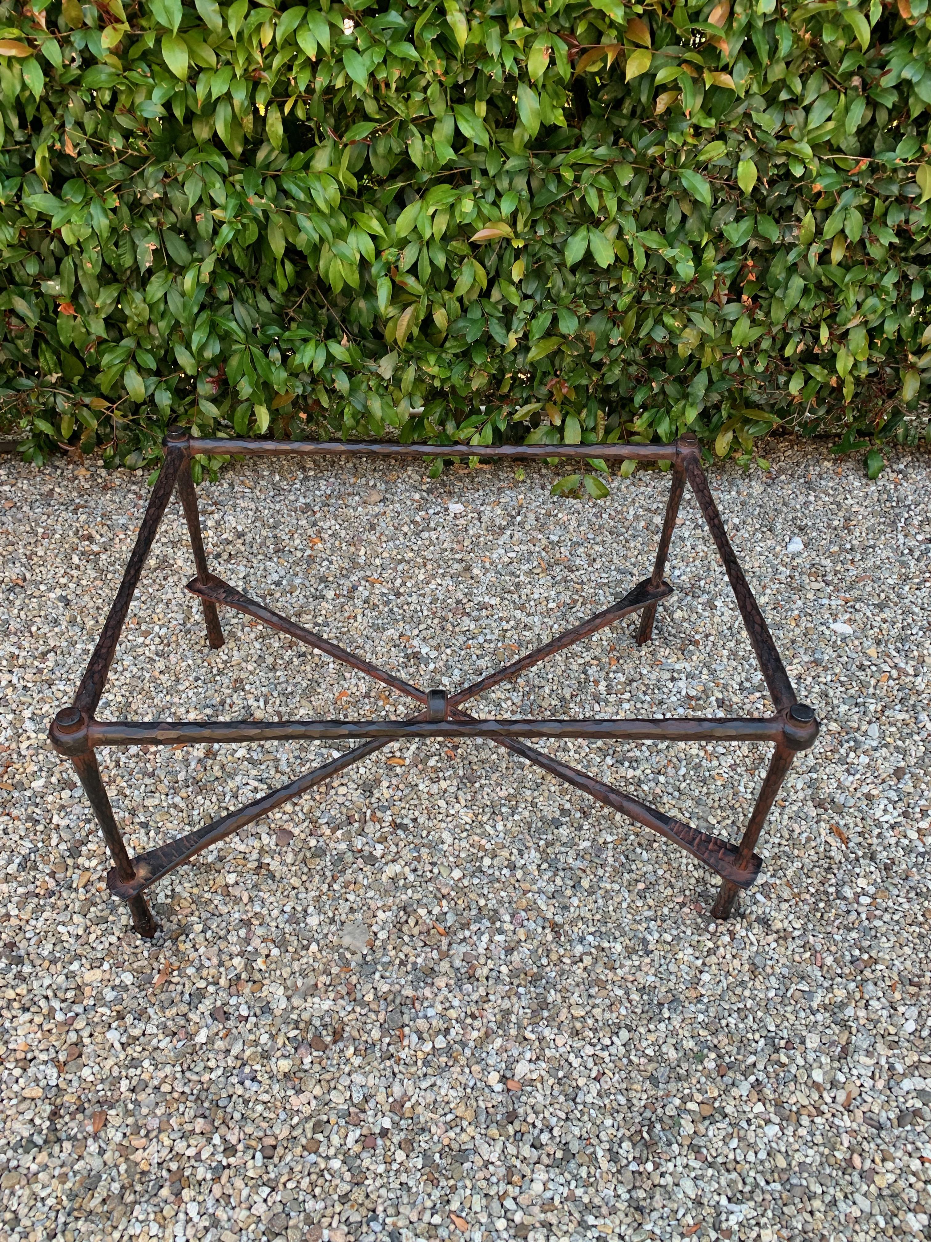 Wrought iron coffee table in the manner of Giacometti - a beautiful hammered wrought iron table. The finish on the iron has a reddish cast to the black iron, this could easily be changed. The piece is very well made and has a 1/2 inch glass top.