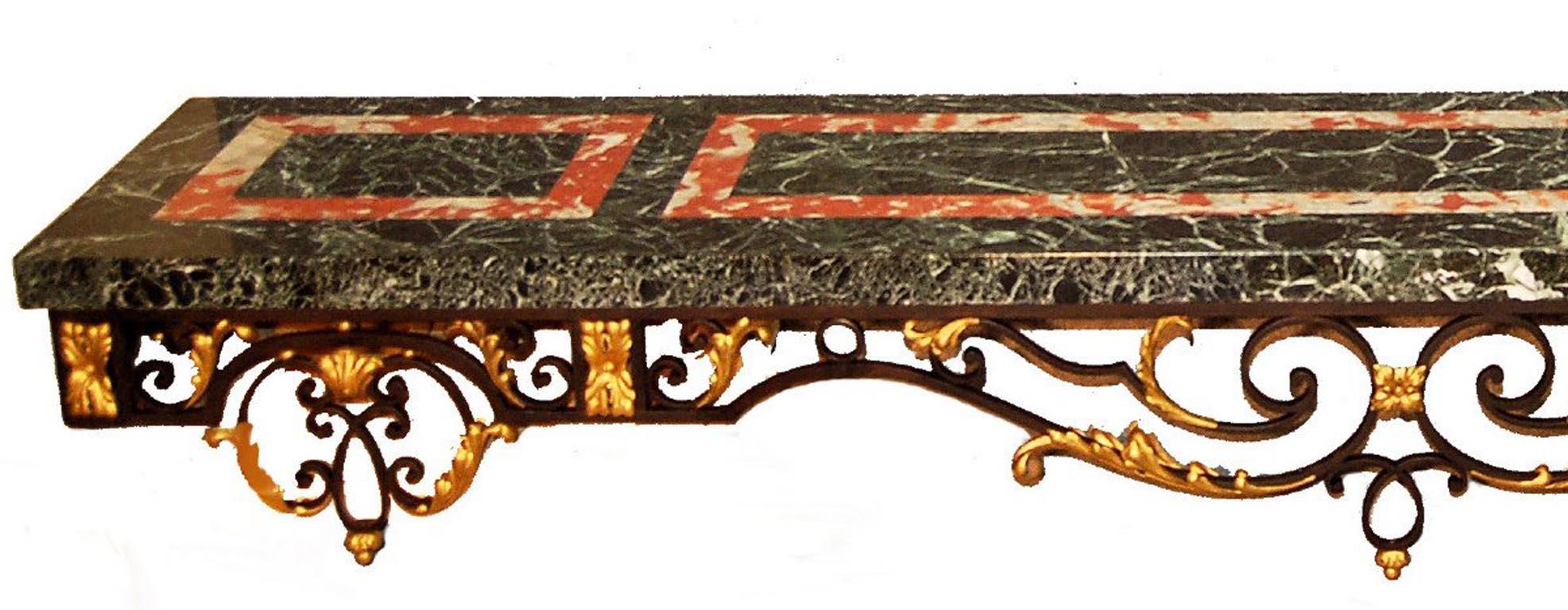 Important and exceptional Baroque style wrought iron console with black and gold patina. Important green marble top with royal red marble inlays. The construction is traditional technique. Period late nineteenth century.
Weight about 300 kg, 660