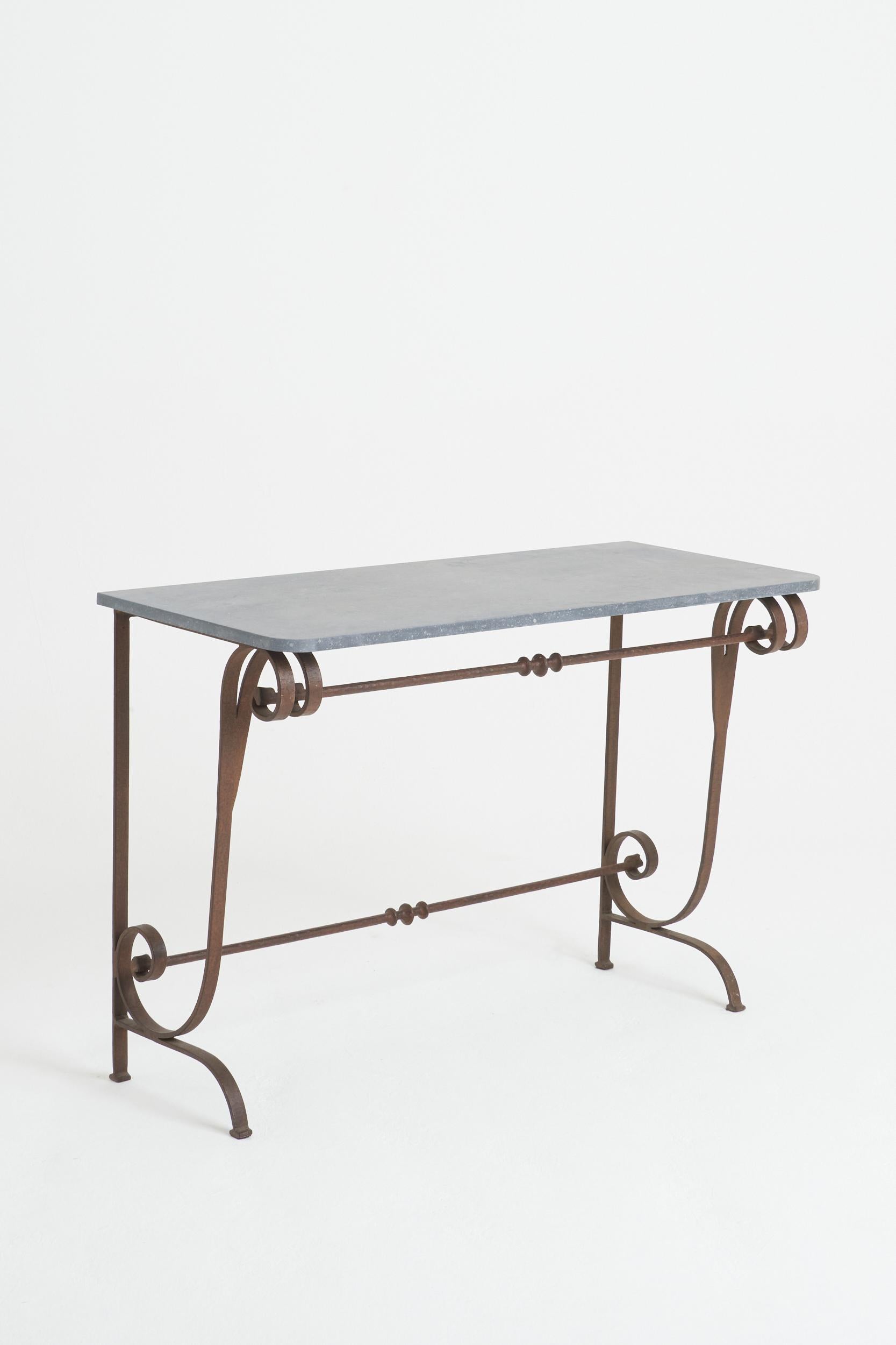 A stone top wrought iron console table.
France, mid-20th century
74.5 cm high by 110 cm wide by 48 cm depth.
