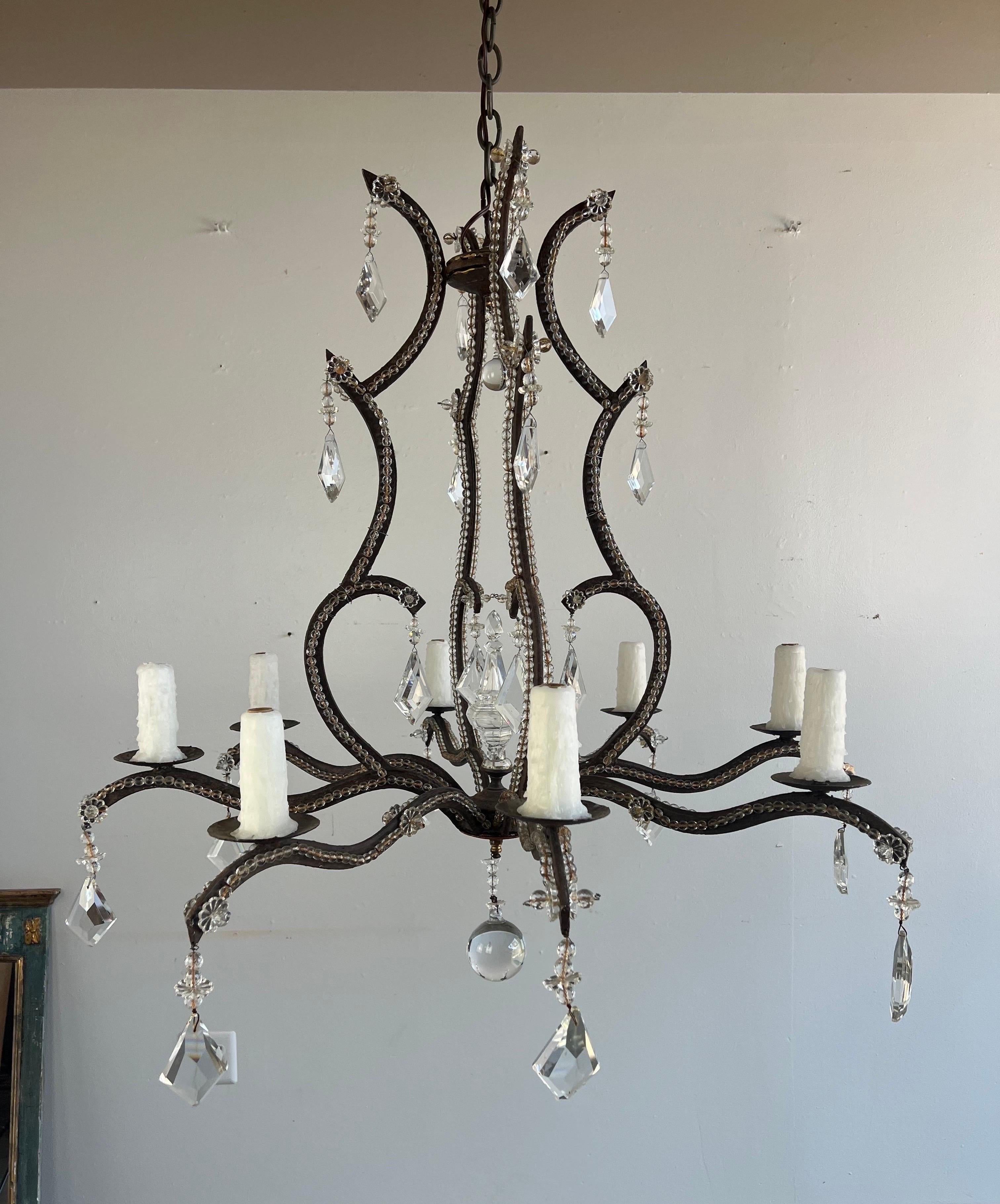 1930's Spanish wrought iron (8) light chandelier with diamond shaped crystals throughout.  The chandelier is newly rewired with drip wax candle covers.  Includes chain & canopy.
