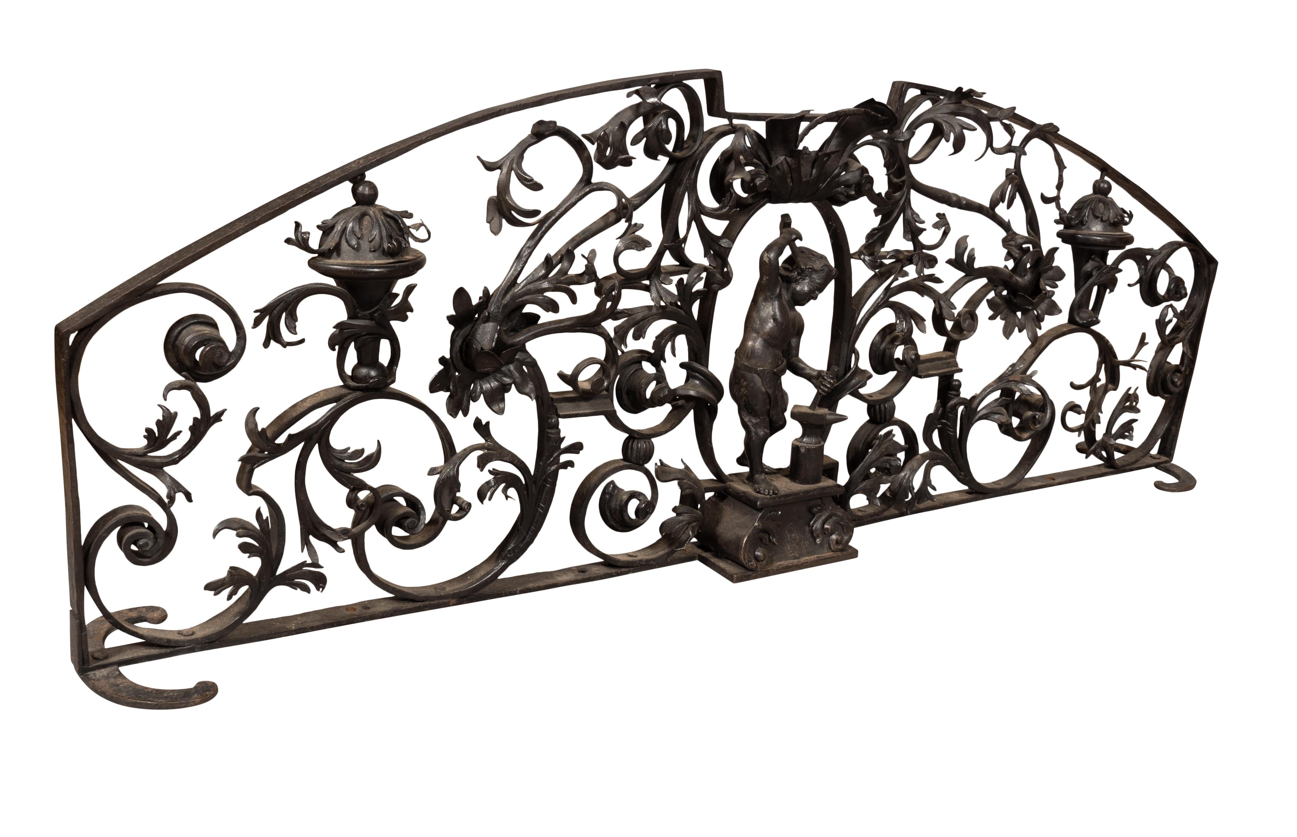 Arch form and not sure of its original intension. Center depicting a boy with hammer and anvil. Surrounded by scrolling leaf decoration.
