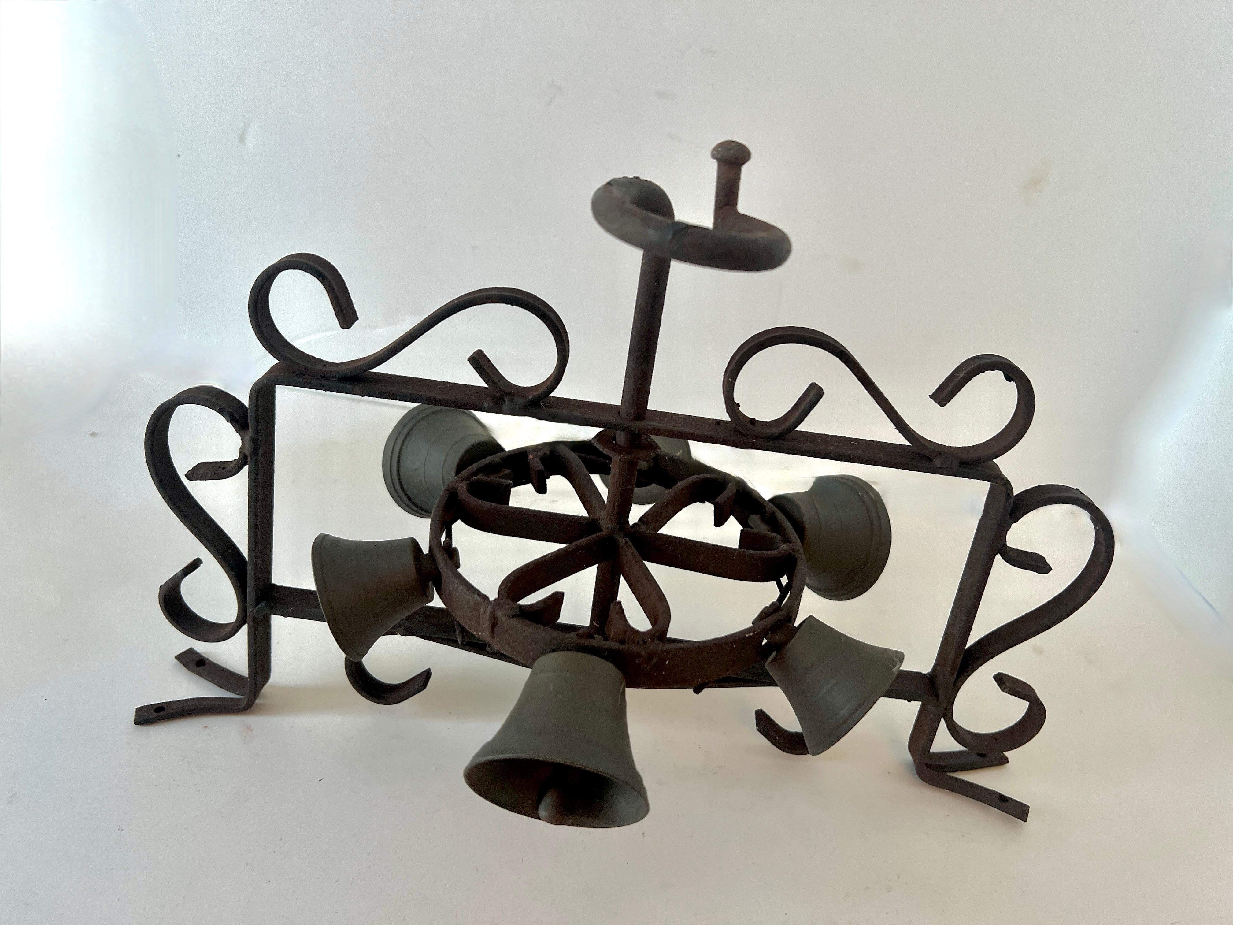 A wonderfully unique door, entry or reminder bell.

A succession of hand wrought bells in a circular motion, when rotated by the handle produce a lovely and spontaneous series of bells.  A compliment to the back door, to call in those for lunch or