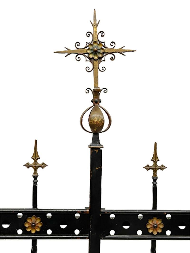 Wrought iron entrance gate or garden fence

A two part wrought iron entrance gate or garden fence with floral ornaments
and cross baluster head finials and top ornament. The iron ballusters in between are twisted.
Key (in working condition), 4