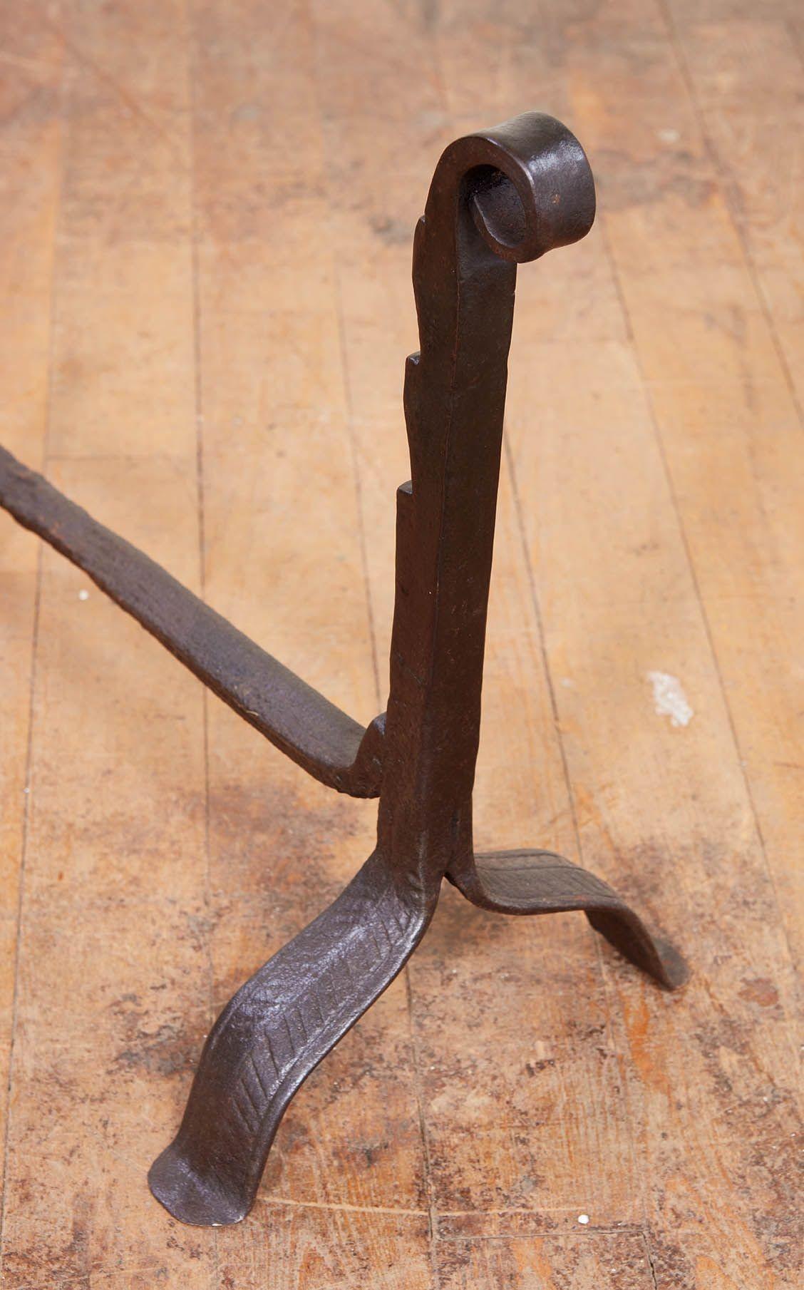 Good pair of blacksmith made fiddle head andirons in wrought iron, having notched neck and standing on arched legs with blunt feet, probably Flemish.