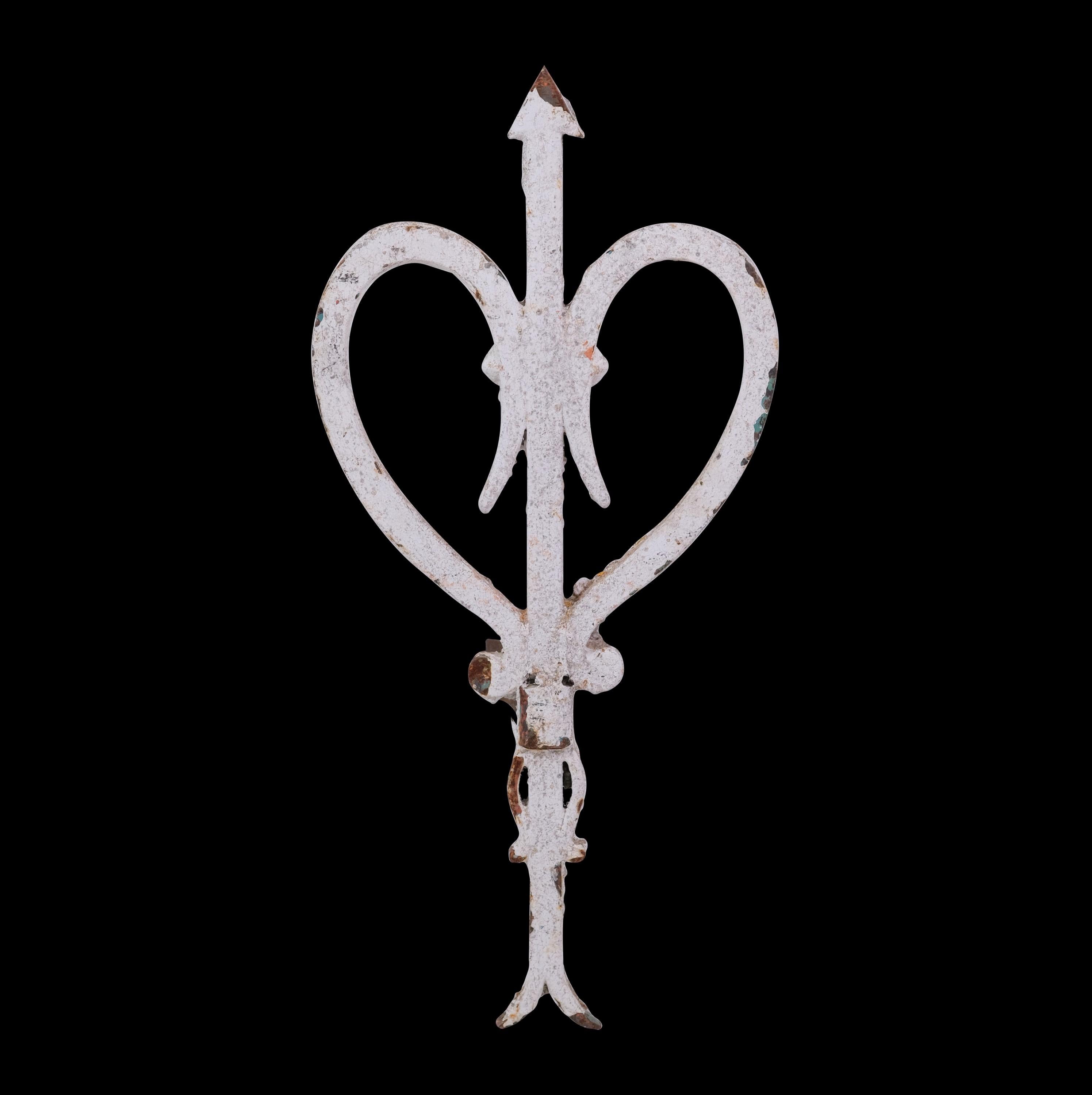 From Europe, wrought iron finial with a heart and arrow design. Original white paint with minor rusting. This can be seen at our 400 Gilligan St location in Scranton, PA.