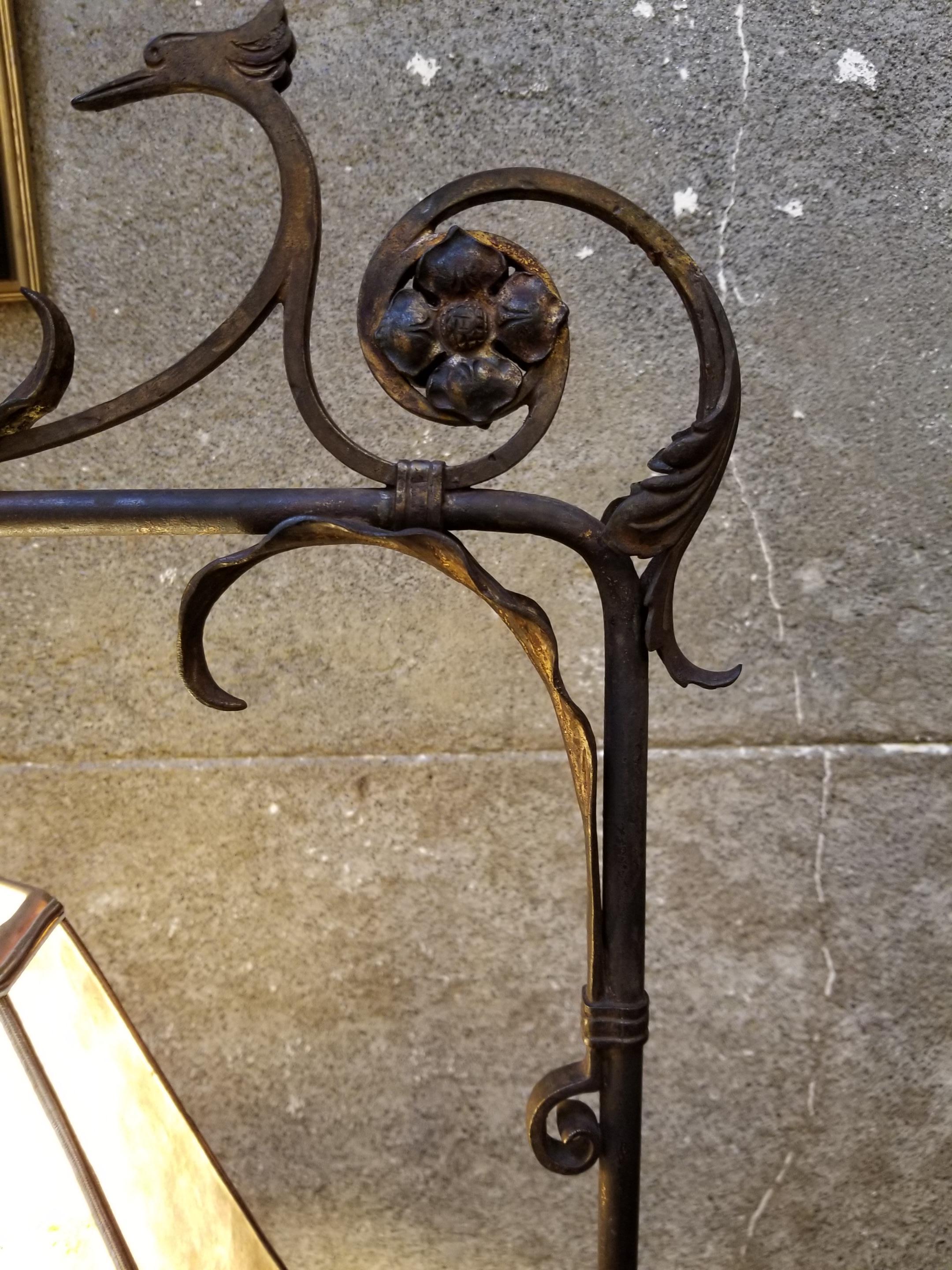 A 1920s Spanish Revival hand wrought iron floor or bridge lamp with a period mica lamp shade. Serpent or dragon with acanthus leaf motif. In the manner of Oscar Bach or Samuel Yellin. Adjustable height between 51.5 inches to 67 inches. Adjustable