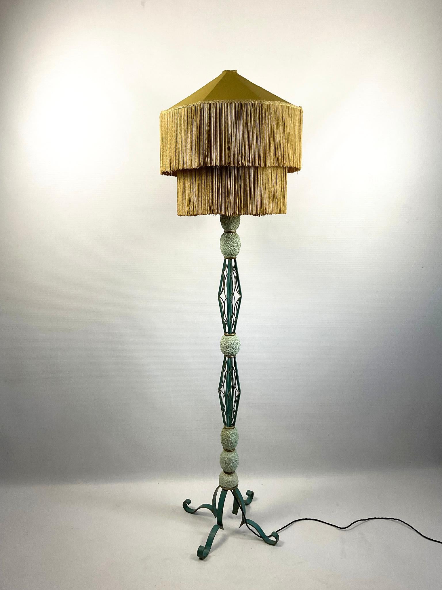 French floor lamp from the 1940s in wrought iron with a turquoise and gold enamel finish. Adorned with elliptical ceramic eggshell decorations.
Art deco two-tier silk bohemian fringed lampshade
Lampshade dimensions :
Top Diameter : 50cm
Bottom