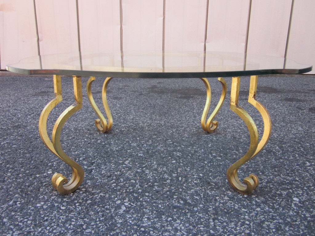Gold gilt wrought iron glass top coffee table. Some scratches to the glass. Attributed to Maison Ramsay.