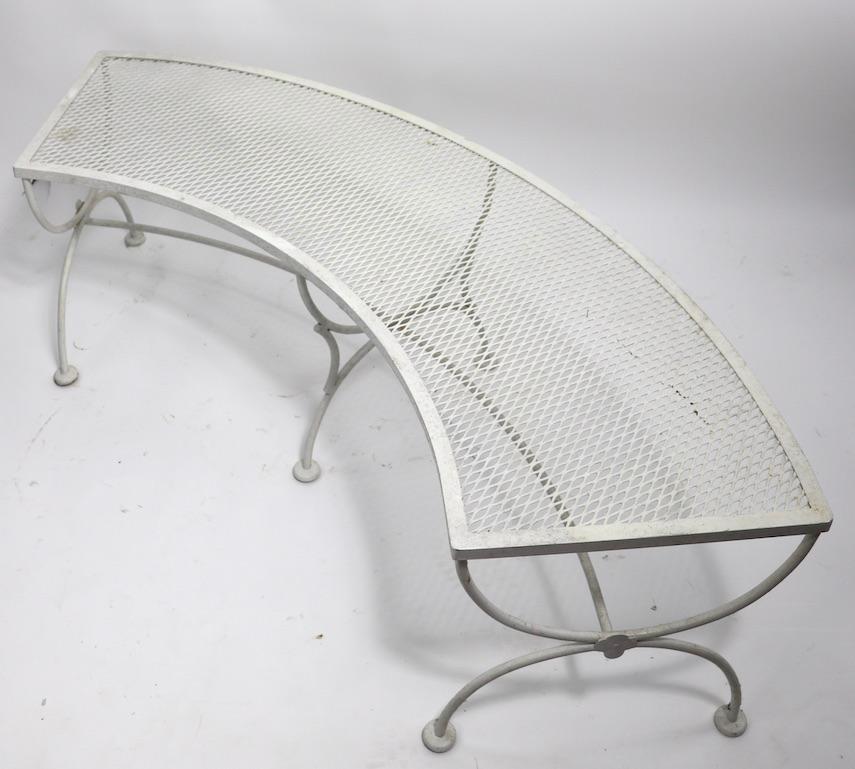 Curved garden bench(s) by Salterini perfect for garden, patio or poolside use. Each bench has a wrought iron base, and metal mesh top. Offered and priced individually, but we would love to see them stay together. Currently in older white paint