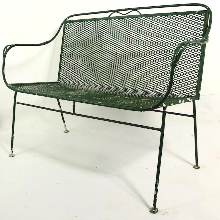 Stylish love seat, bench settee by Salterini. The love seat has a wrought iron frame, with metal mesh backrest and seat, it is currently in later but not new, green paint finish.
Total H 33 x Arm H 26 x Seat H 17 inches.
We offer custom powder