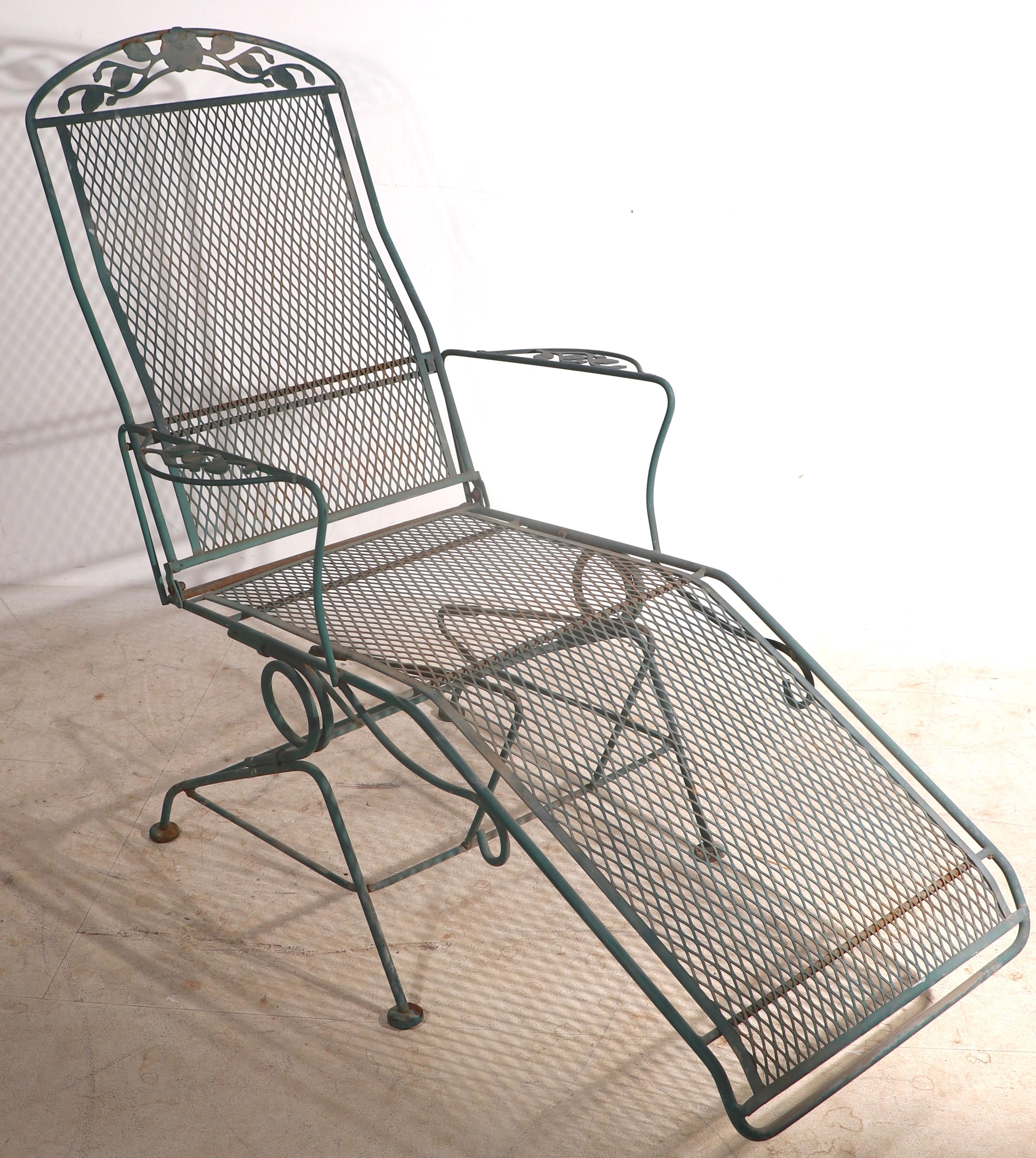 Chaise, lounge chair of wrought iron, and metal mesh, by Meadowcraft, from the Dogwood series, circa 1950/1960's. The chair is solid, stable and fully functional, the finish shows cosmetic wear to the finish, normal and consistent with age. The